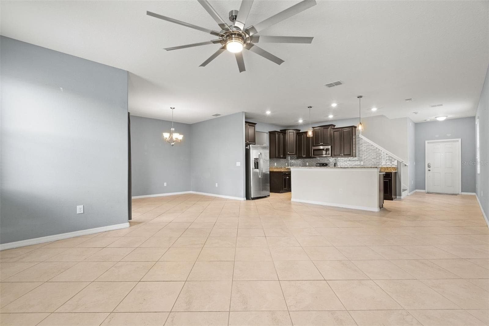 Open Floor Plan — Expansive open-concept living and dining space with easy flow into the kitchen and outdoor living area. - 13728 REINDEER CIR, HUDSON