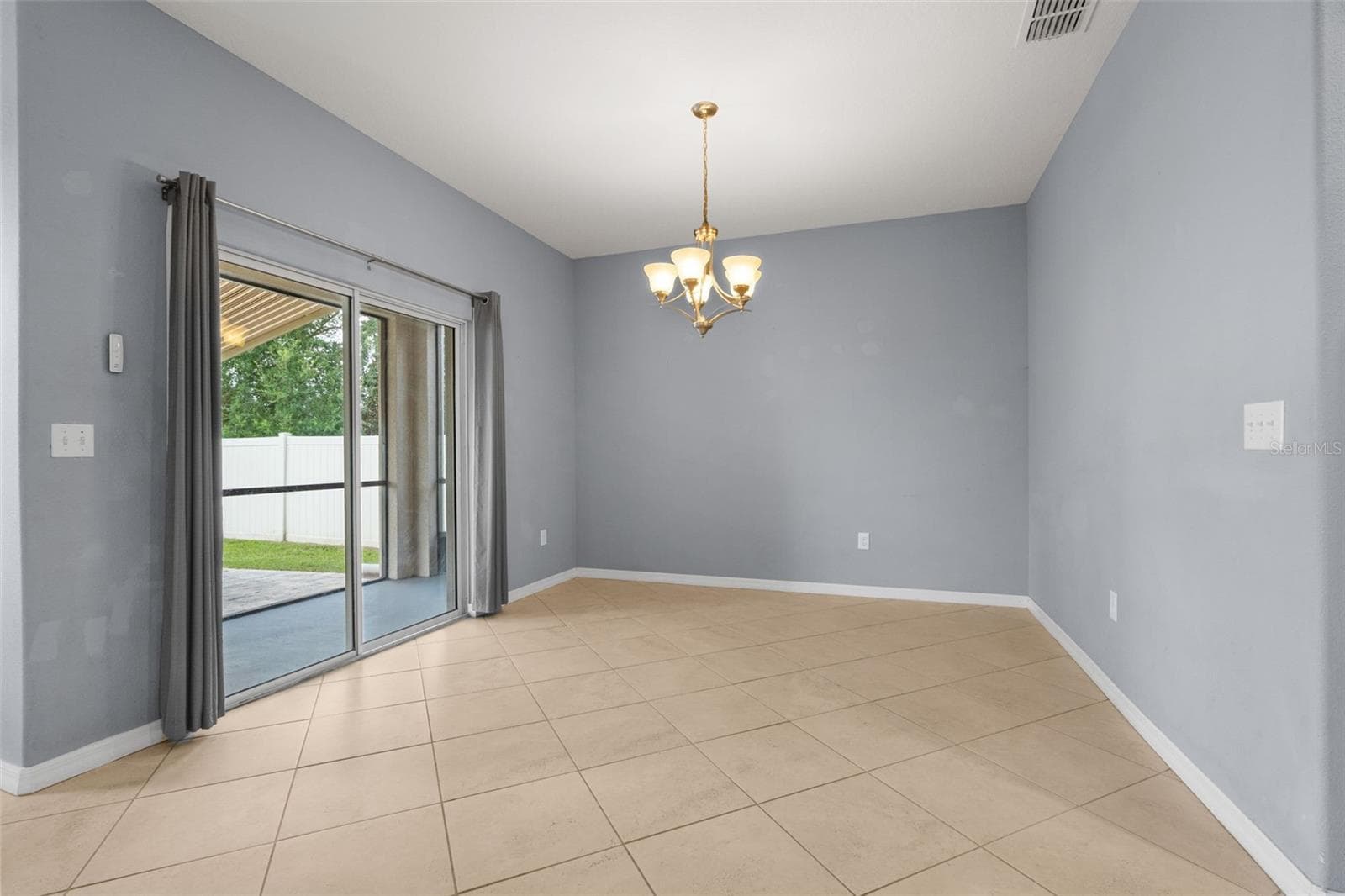Dining Area — Dedicated dining area with sliding glass doors providing direct access to the screened lanai. - 13728 REINDEER CIR, HUDSON