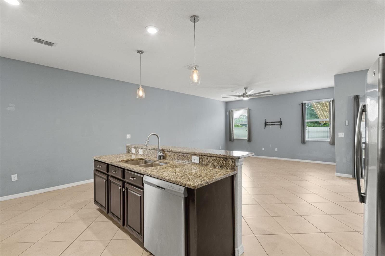 Kitchen — Additional kitchen view showcasing extensive counter space, cabinetry, recessed lighting, and stainless-steel appliances. - 13728 REINDEER CIR, HUDSON