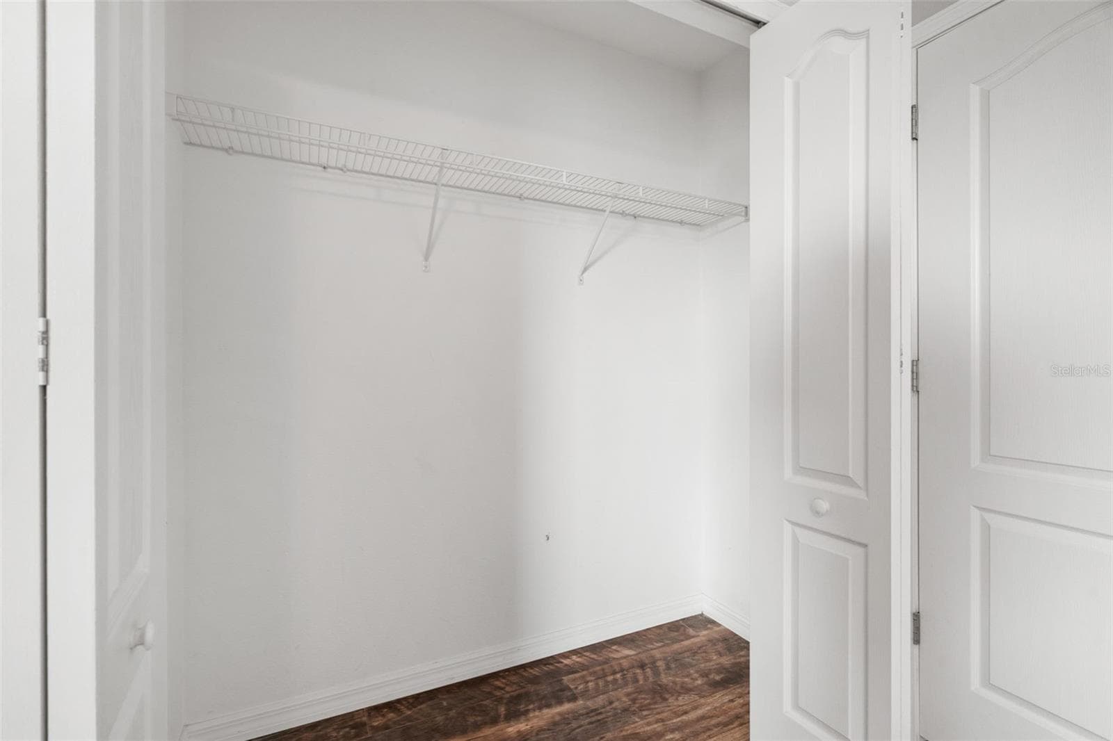 Bedroom Closet – Large closet with wire shelving providing plenty of storage space. - 13728 REINDEER CIR, HUDSON