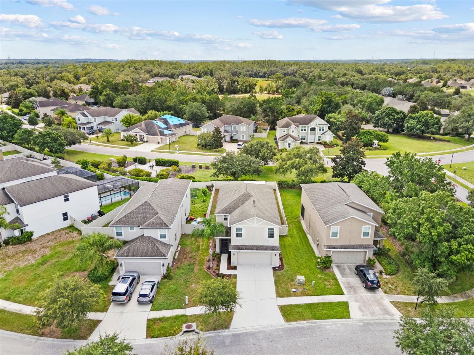 Aerial Property View – Aerial view highlighting the home, surrounding neighborhood, and nearby green space. - 13728 REINDEER CIR, HUDSON