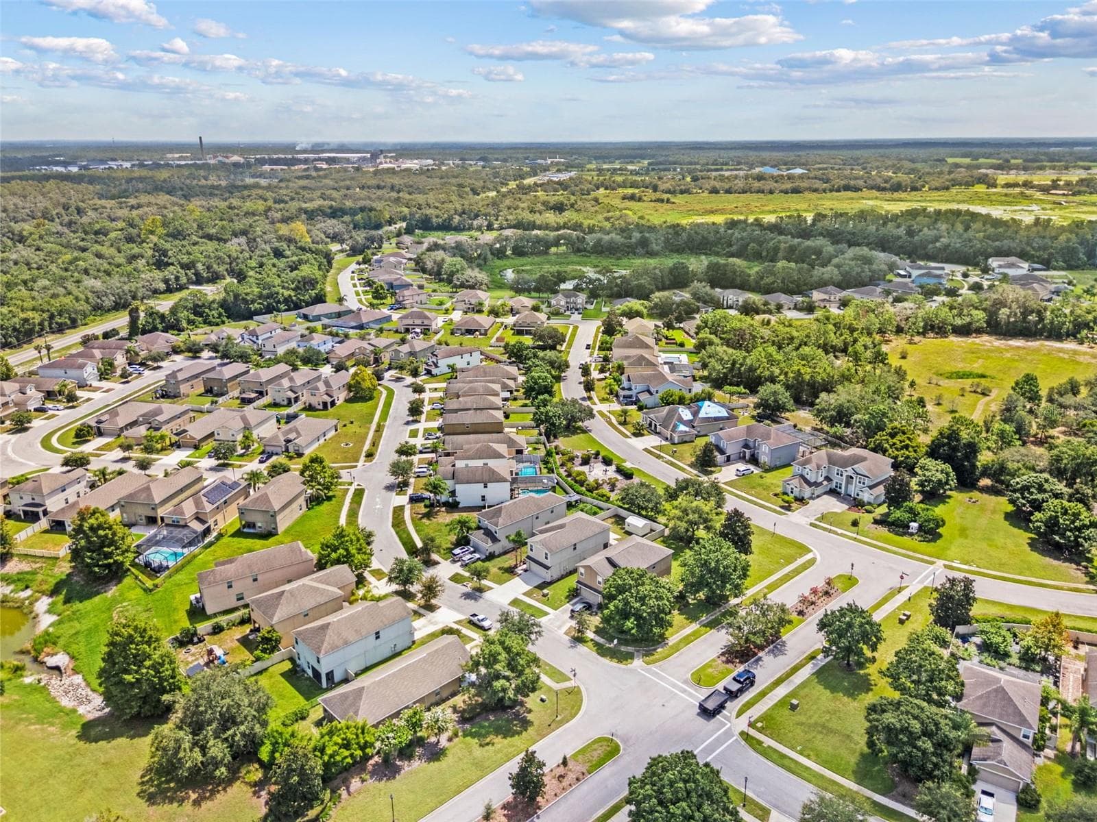Community Aerial – Expansive aerial perspective of the Lakeside neighborhood and surrounding natural areas. - 13728 REINDEER CIR, HUDSON