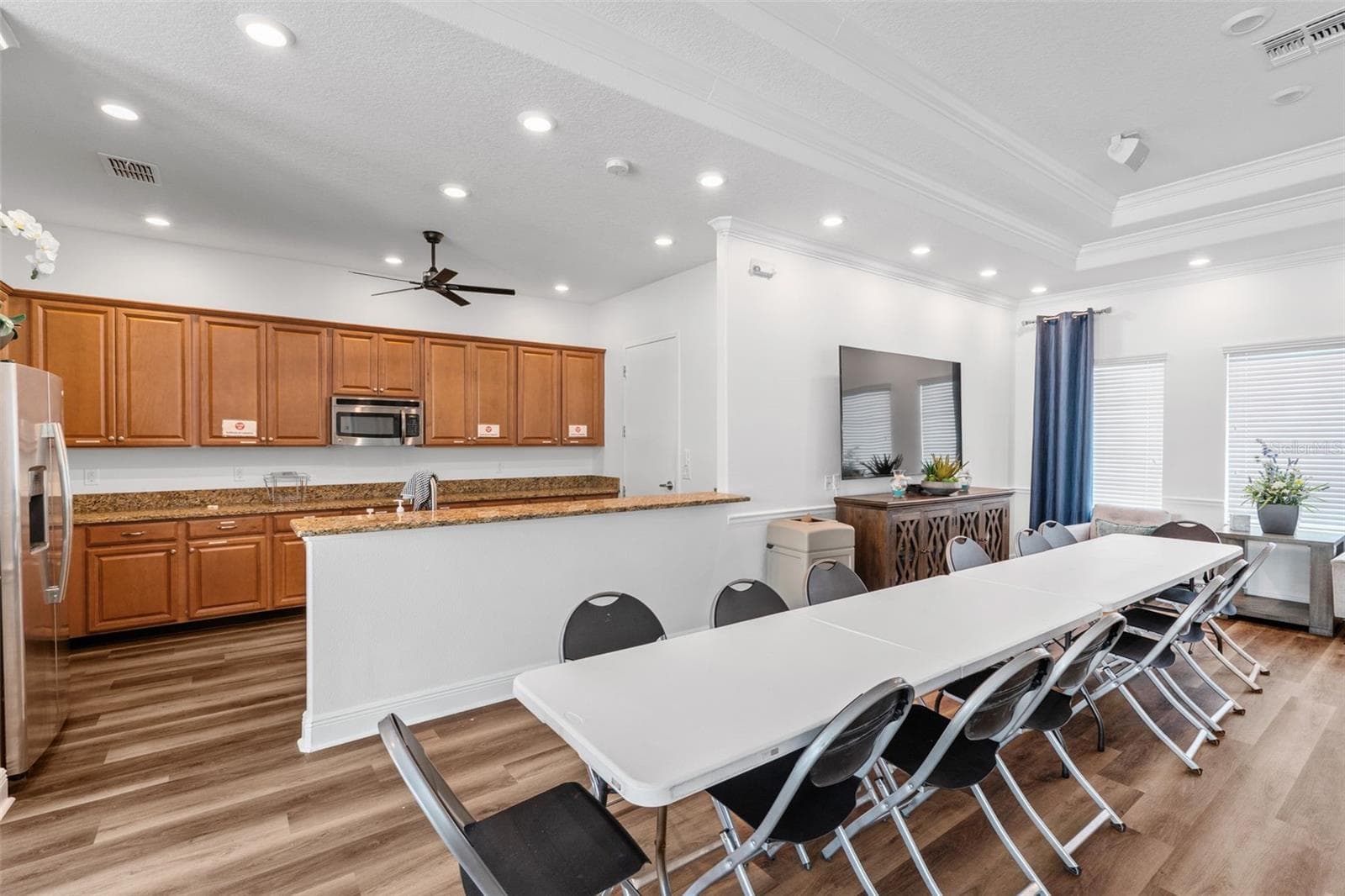 Clubhouse Kitchen & Gathering Area – Community clubhouse featuring a kitchen, dining and gathering space for resident use. - 13728 REINDEER CIR, HUDSON