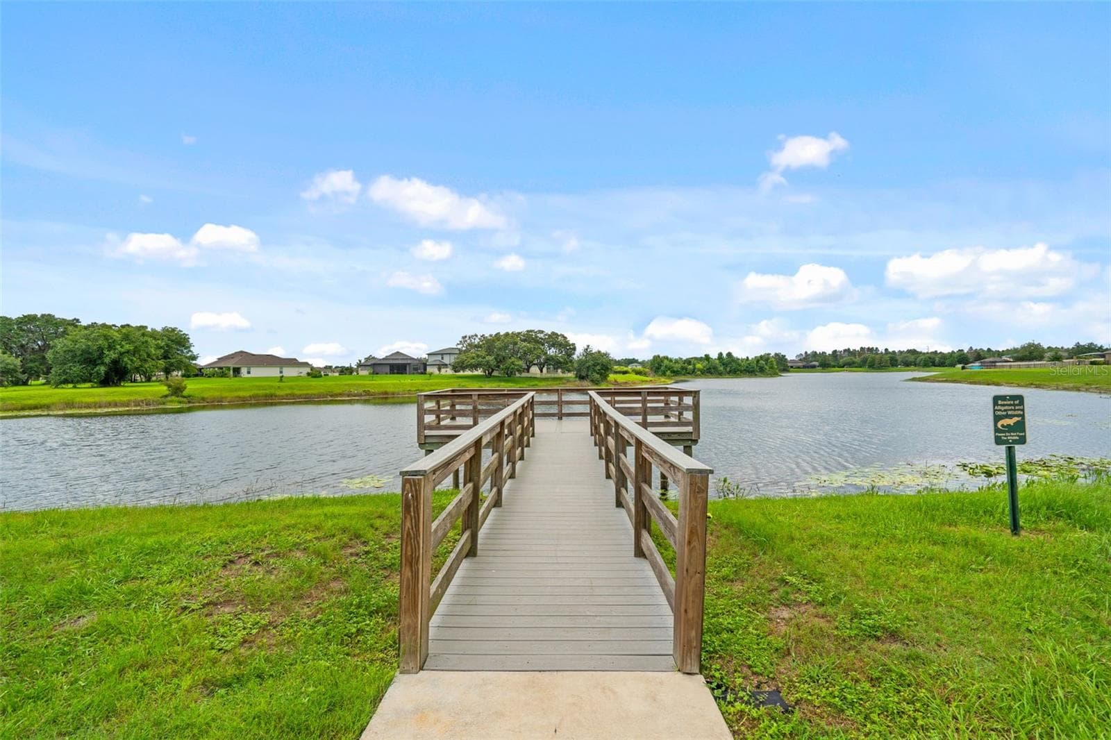 Community Fishing Pier – Community pier extending over the lake, providing a peaceful spot to enjoy the waterfront. - 13728 REINDEER CIR, HUDSON