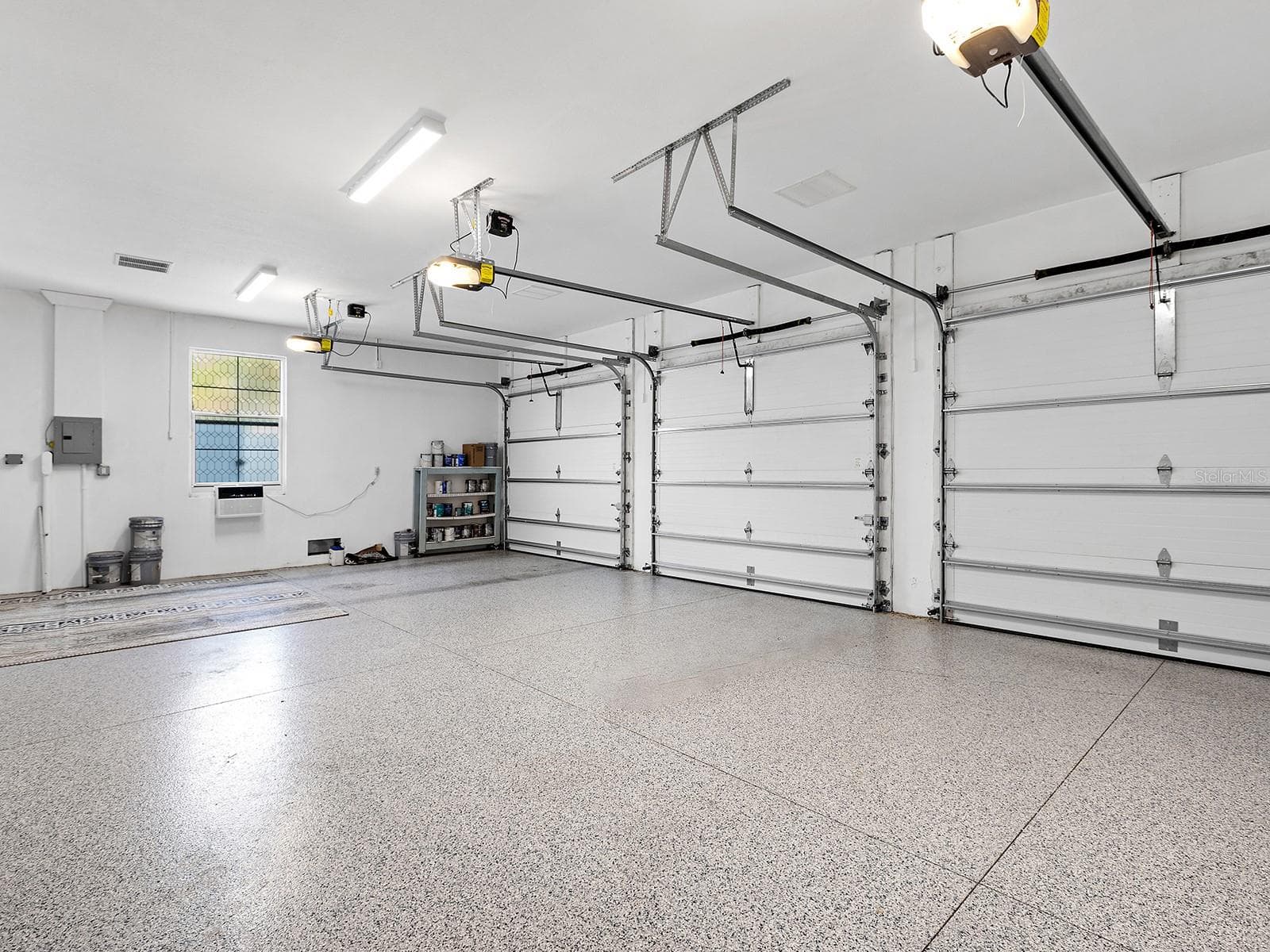 Oversized multi-car garage with epoxy flooring, high clearance for equipment, and built-in storage potential - 4024 11TH STREET CT W, PALMETTO