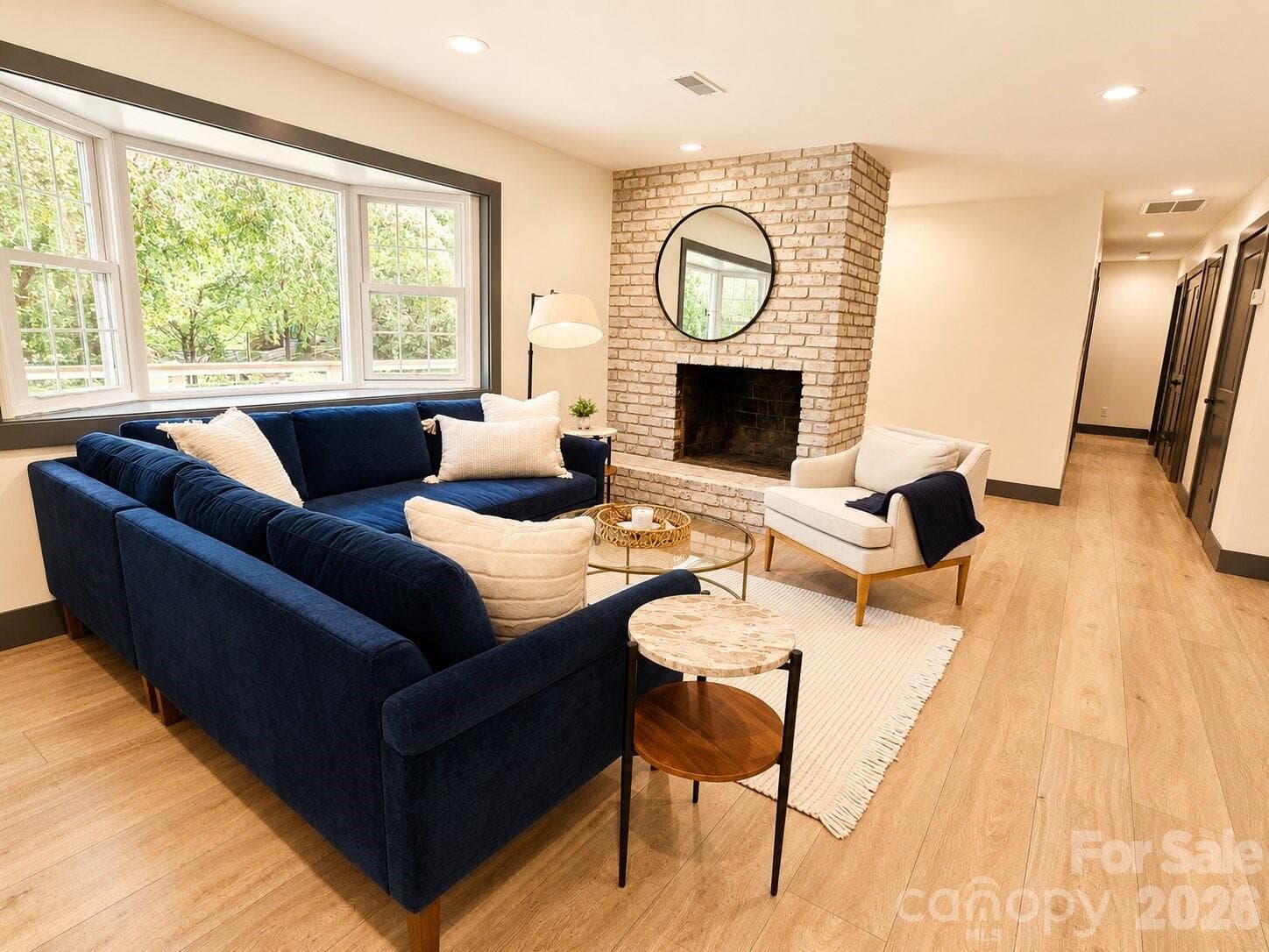 spacious great room with a striking whitewashed brick fireplace - Arden