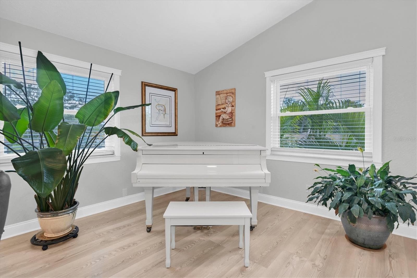 Expansive living room offering flexible space for both living and formal dining; the current owners have beautifully utilized the dining area for their piano. - 6501 MOCKINGBIRD WAY S, GULFPORT