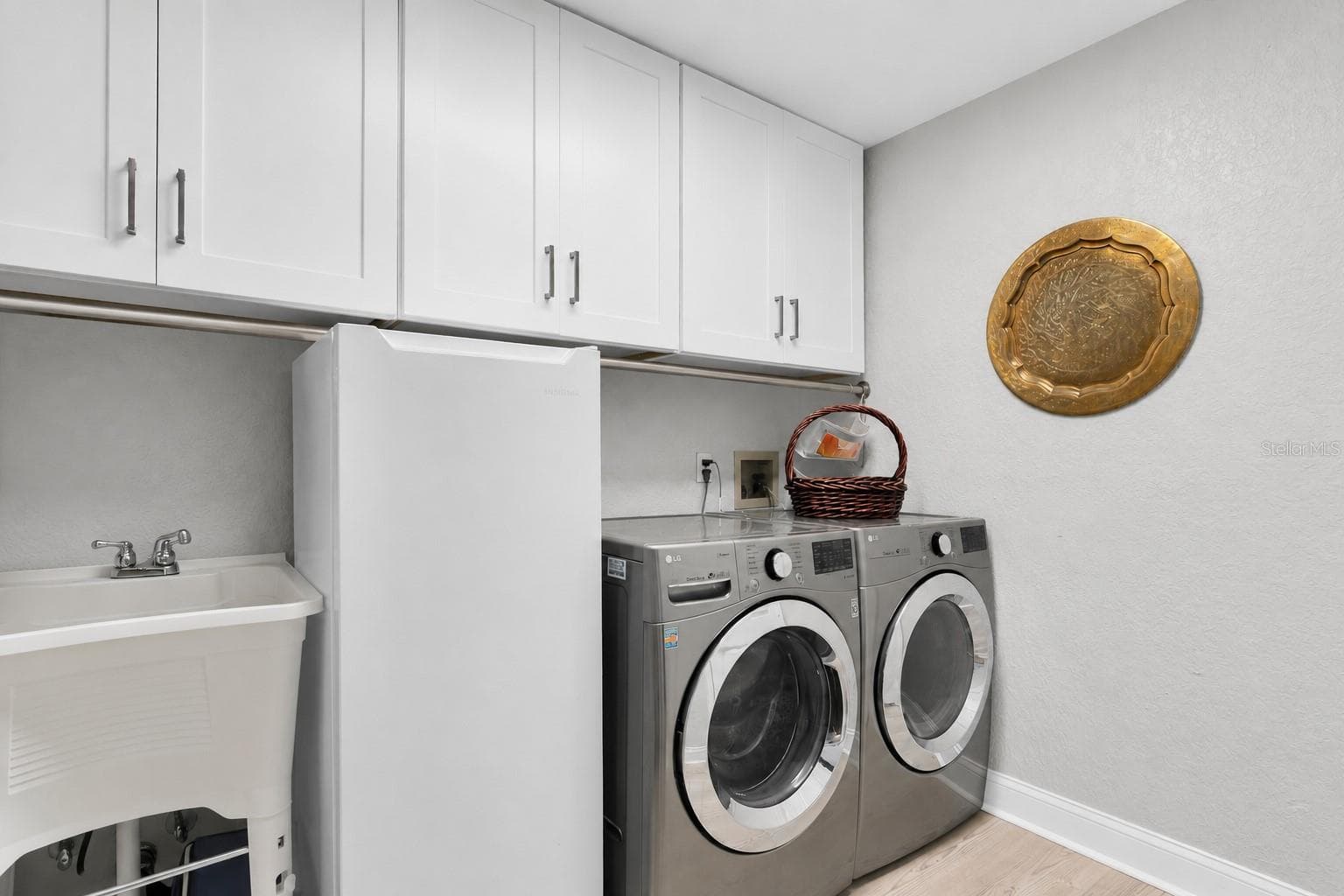 Even laundry feels effortless in this generously sized laundry room, offering additional space for a refrigerator along with ample pantry & storage space. - 6501 MOCKINGBIRD WAY S, GULFPORT