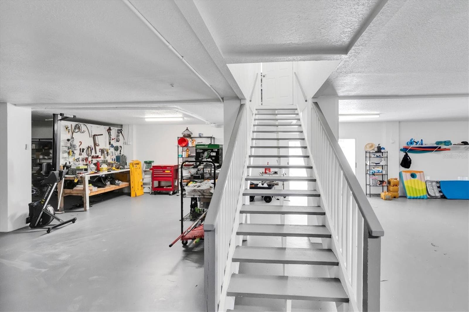 Take the steps down to an enormous garage offering an exceptional amount of space for vehicles, storage, hobbies and so much more. - 6501 MOCKINGBIRD WAY S, GULFPORT