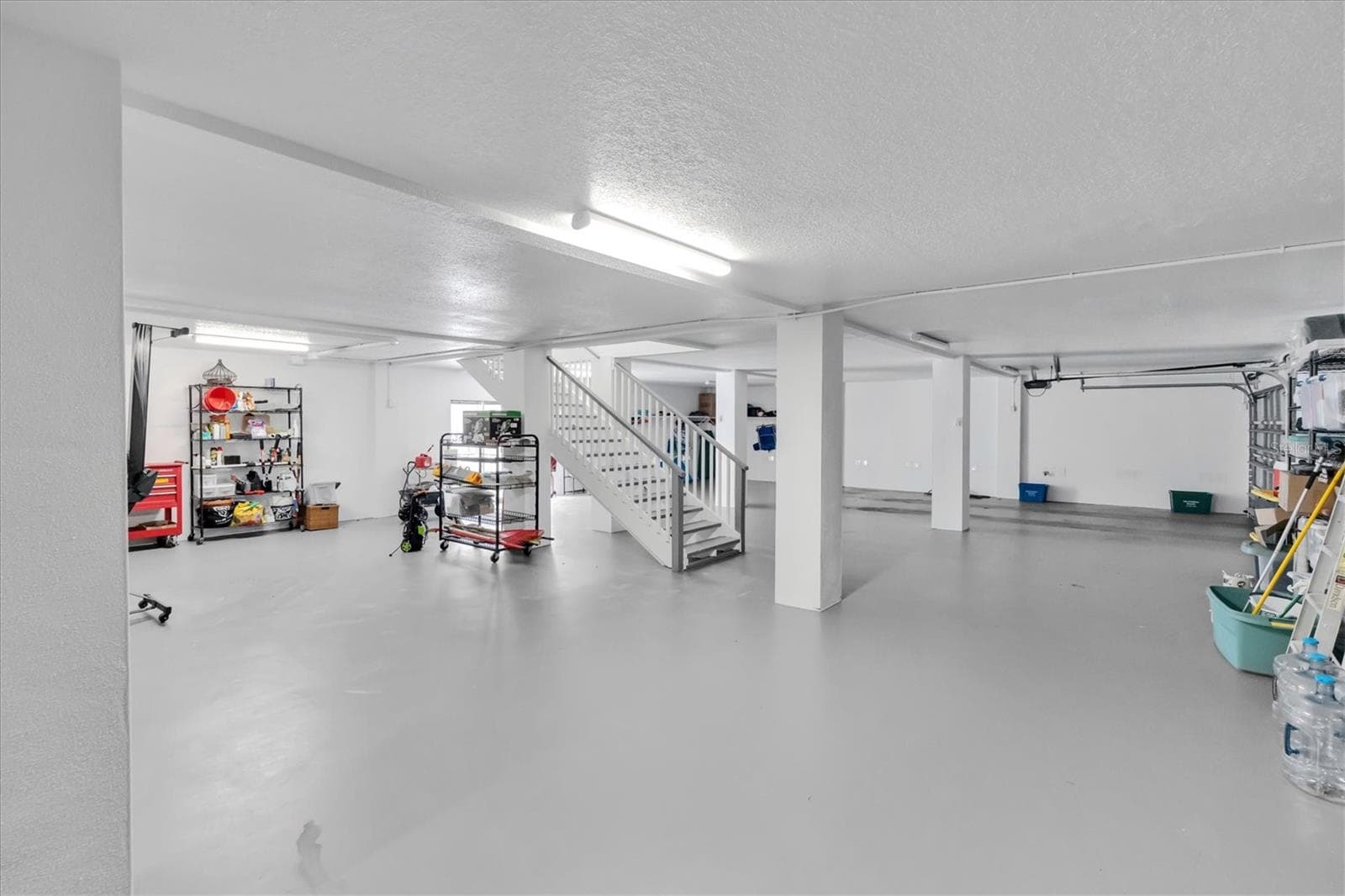 Two separate garage doors provide convenient access to the expansive garage, with ample space to accommodate multiple vehicles with ease. - 6501 MOCKINGBIRD WAY S, GULFPORT