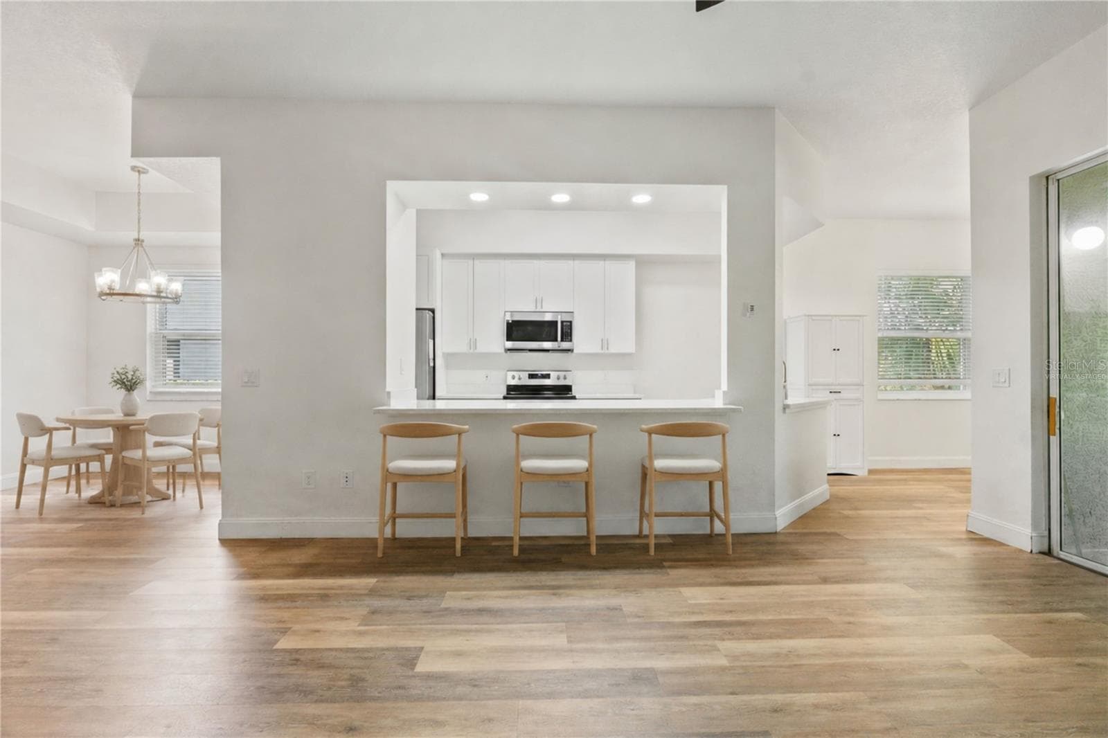 Virtually Staged - Living Room into Kitchen - 9416 MYRTLE CREEK LN #701, ORLANDO