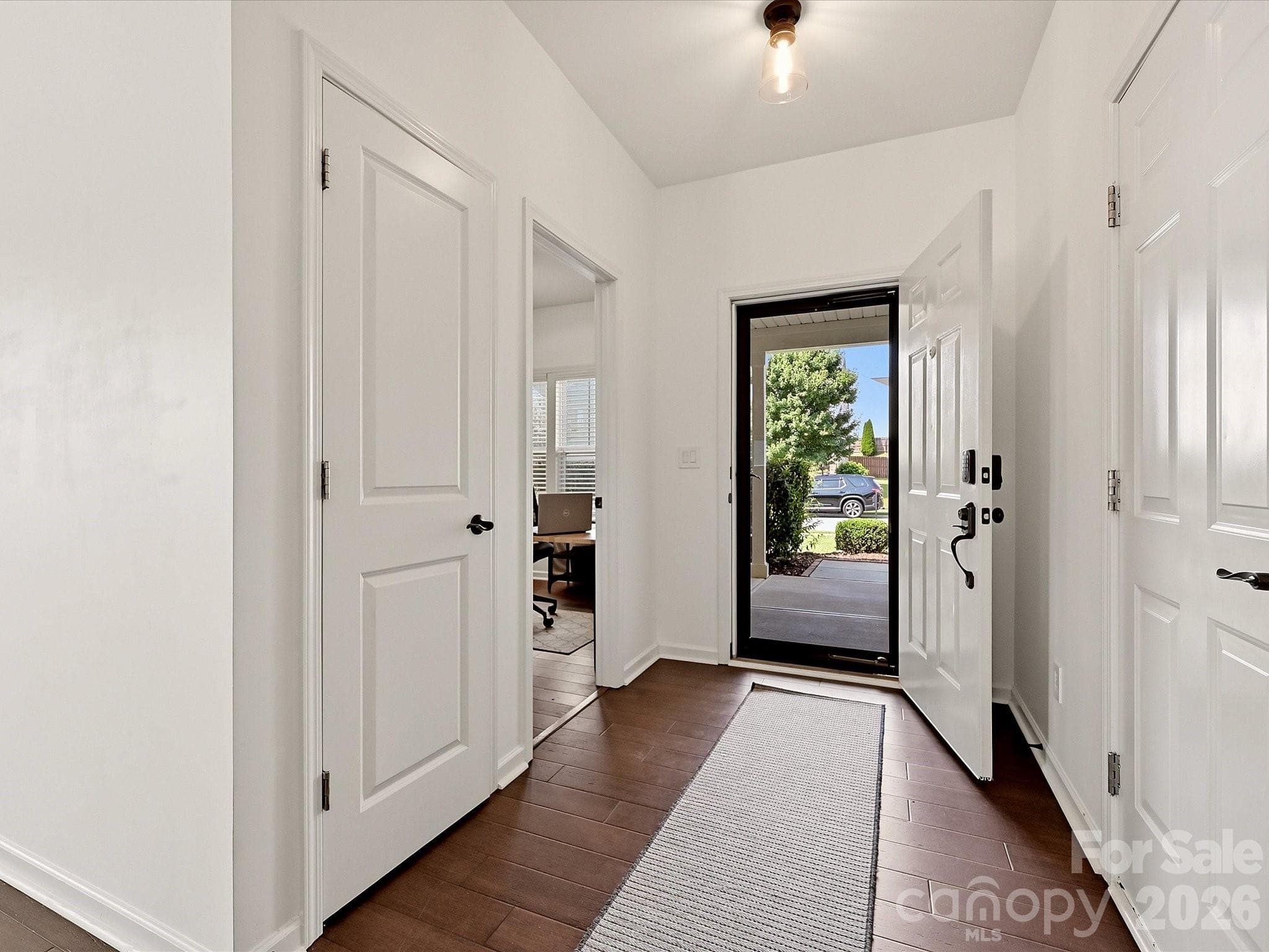 The foyer features a storm door and updated lighting - 216 Austin Field Court, Mount Holly