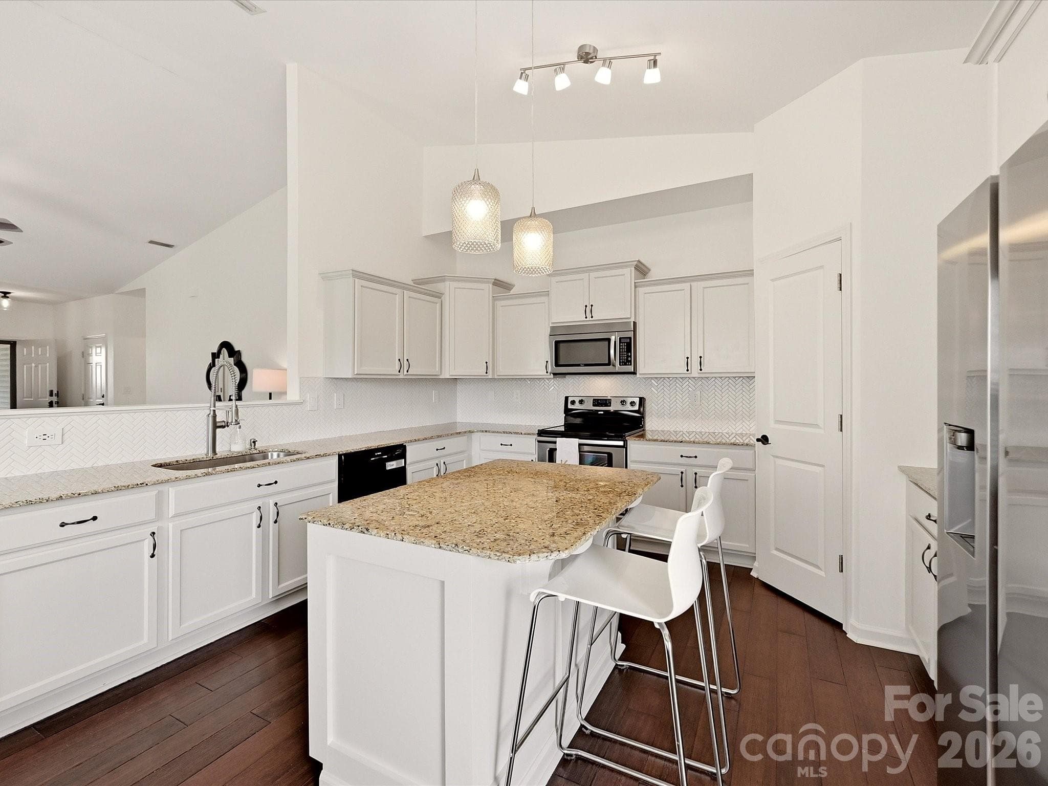 A center island provides bar seating and workspace - 216 Austin Field Court, Mount Holly