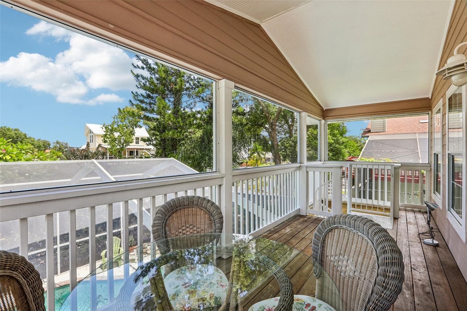 Second floor screened patio and stairs to the pool area - 3131 N CANAL DR, PALM HARBOR