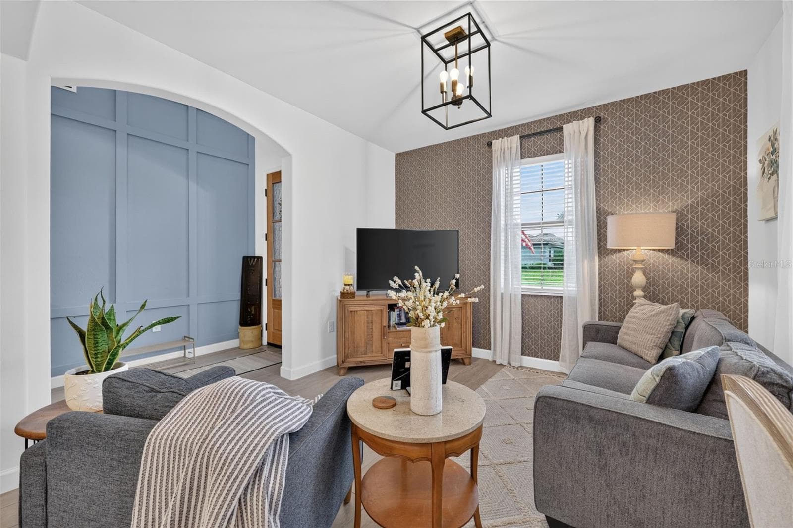 Living Room with Wallpapered Feature Wall and Ceramic Wood Plank Tiles - 15008 MISTY WATER XING, BRADENTON