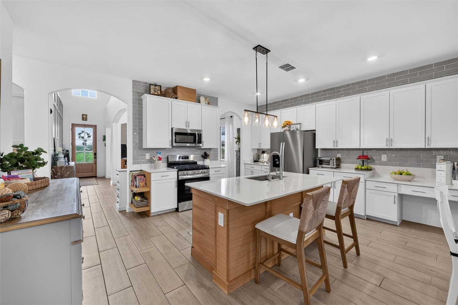 Open Plan Kitchen with White Oak Paneled Center Island and Ceramic Wood Plank Tiles - 15008 MISTY WATER XING, BRADENTON