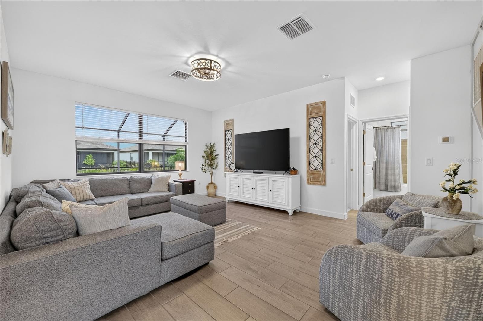 Family Room with Ceramic Wood Plank Tiles and Custom  Accent Wall - 15008 MISTY WATER XING, BRADENTON