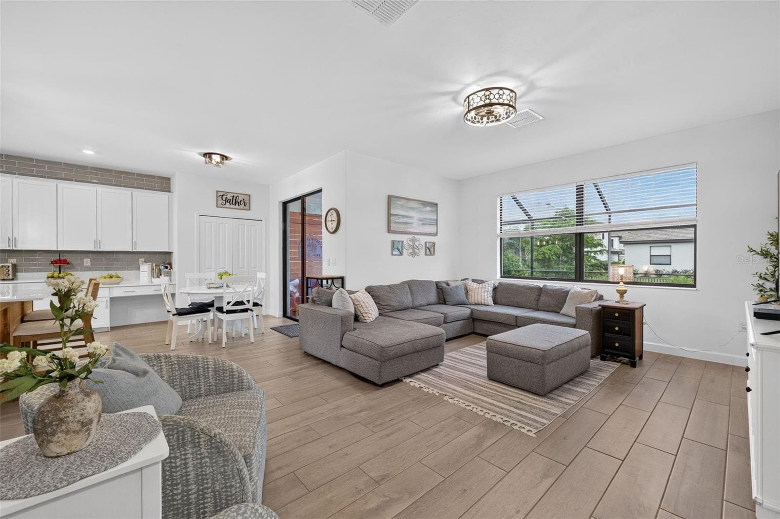 Family Room with Ceramic Wood Plank Tiles and Custom  Accent Wall - 15008 MISTY WATER XING, BRADENTON