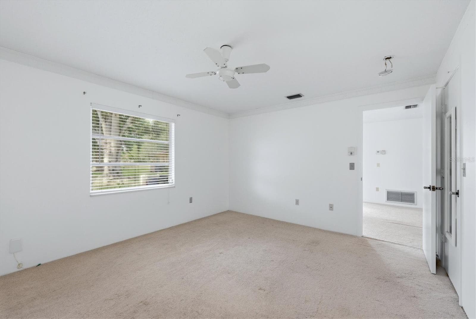 Primary bedroom faces peaceful backyard - 4538 PAWNEE TRL #197, SARASOTA