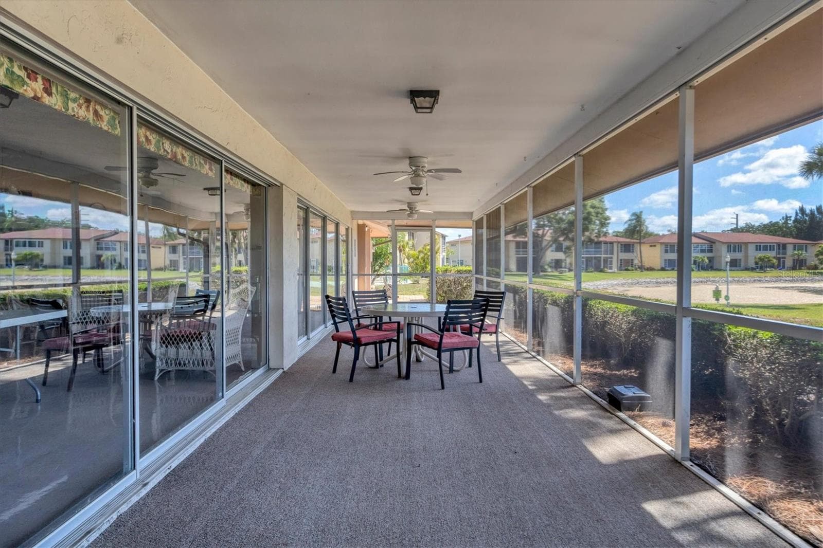 Clubhouse covered lanai overlooks large lake - 4538 PAWNEE TRL #197, SARASOTA
