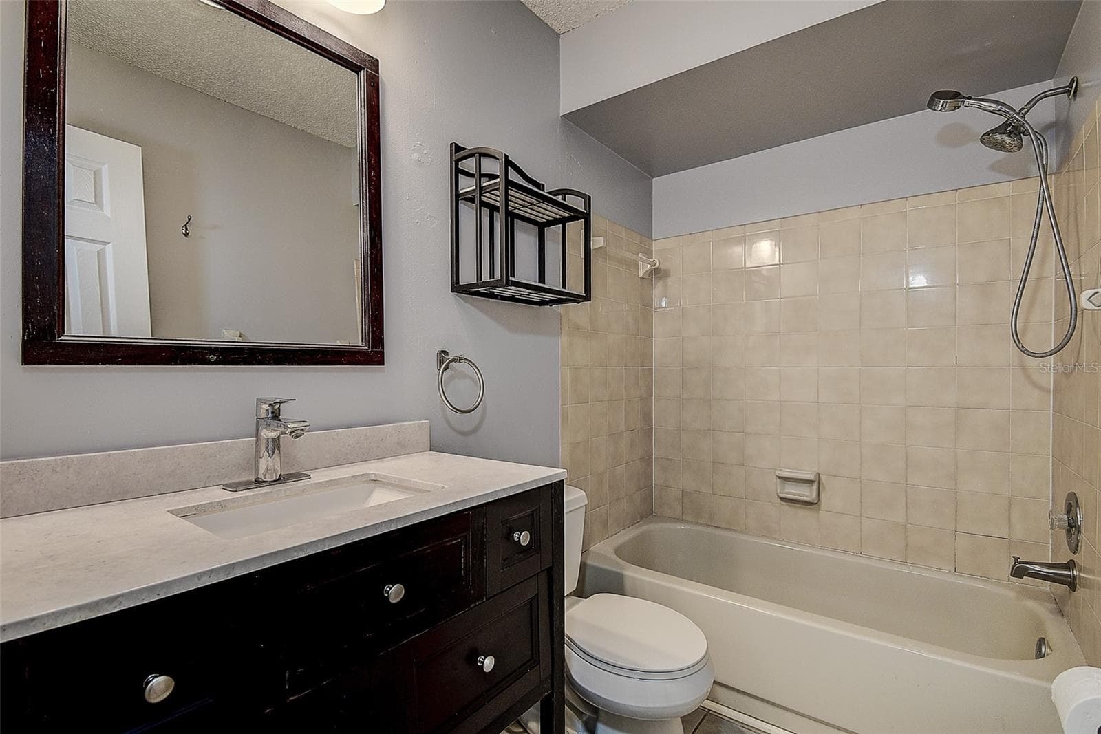 Primary bathroom with wood cabinetry - 10306 COUNCILS WAY, TEMPLE TERRACE