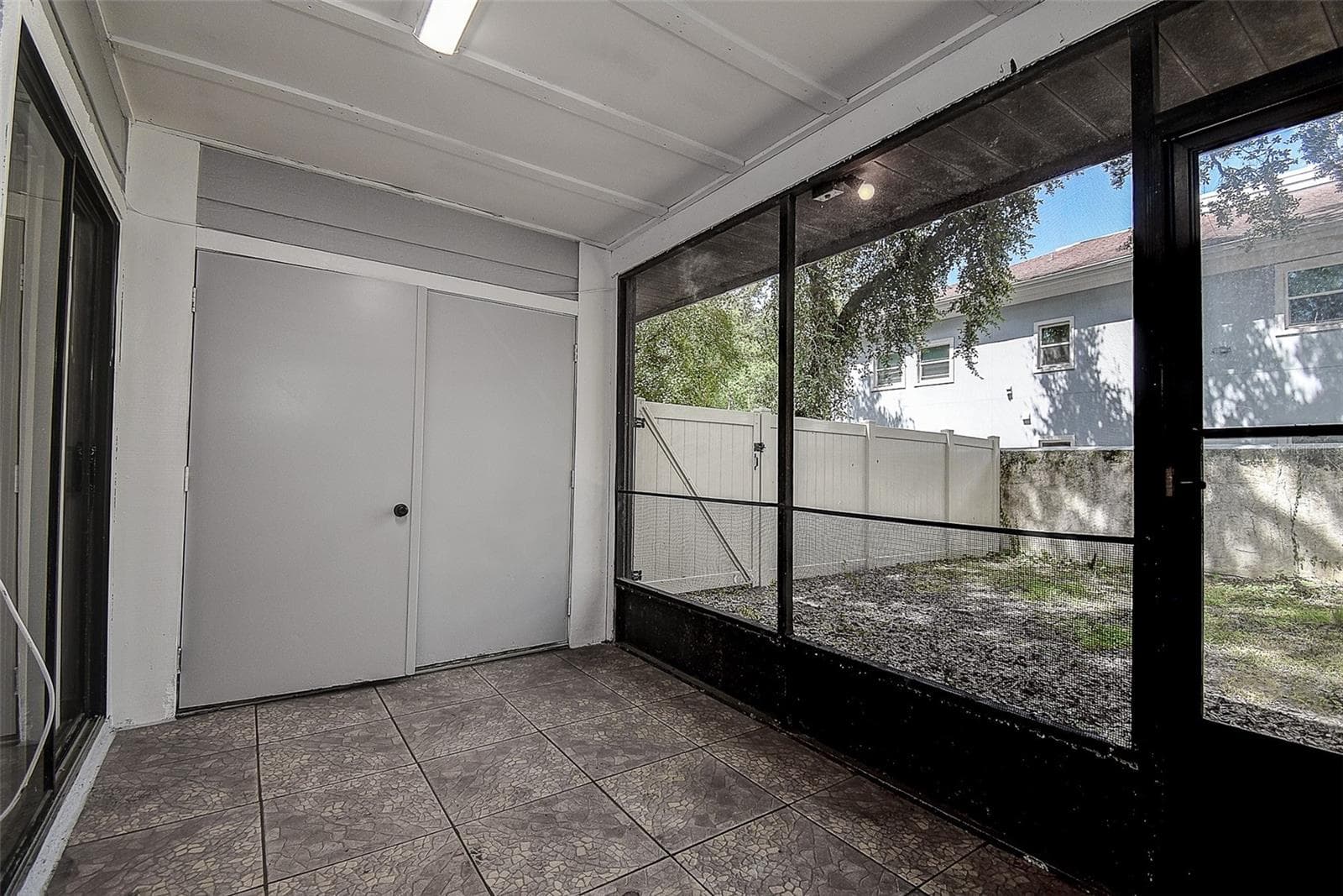 Screened Back patio double doors are storage/laudnry - 10306 COUNCILS WAY, TEMPLE TERRACE