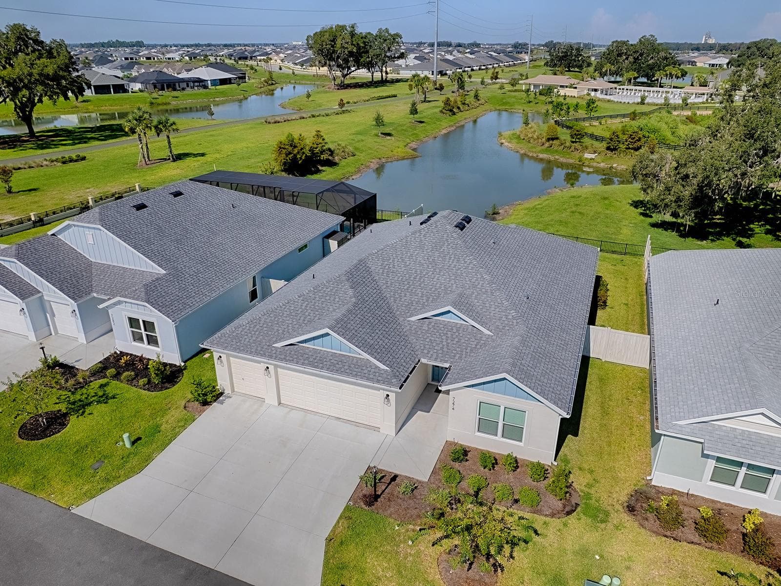 Right Side view of the house and the pond in the backyard - 7274 CARLOS CT, THE VILLAGES