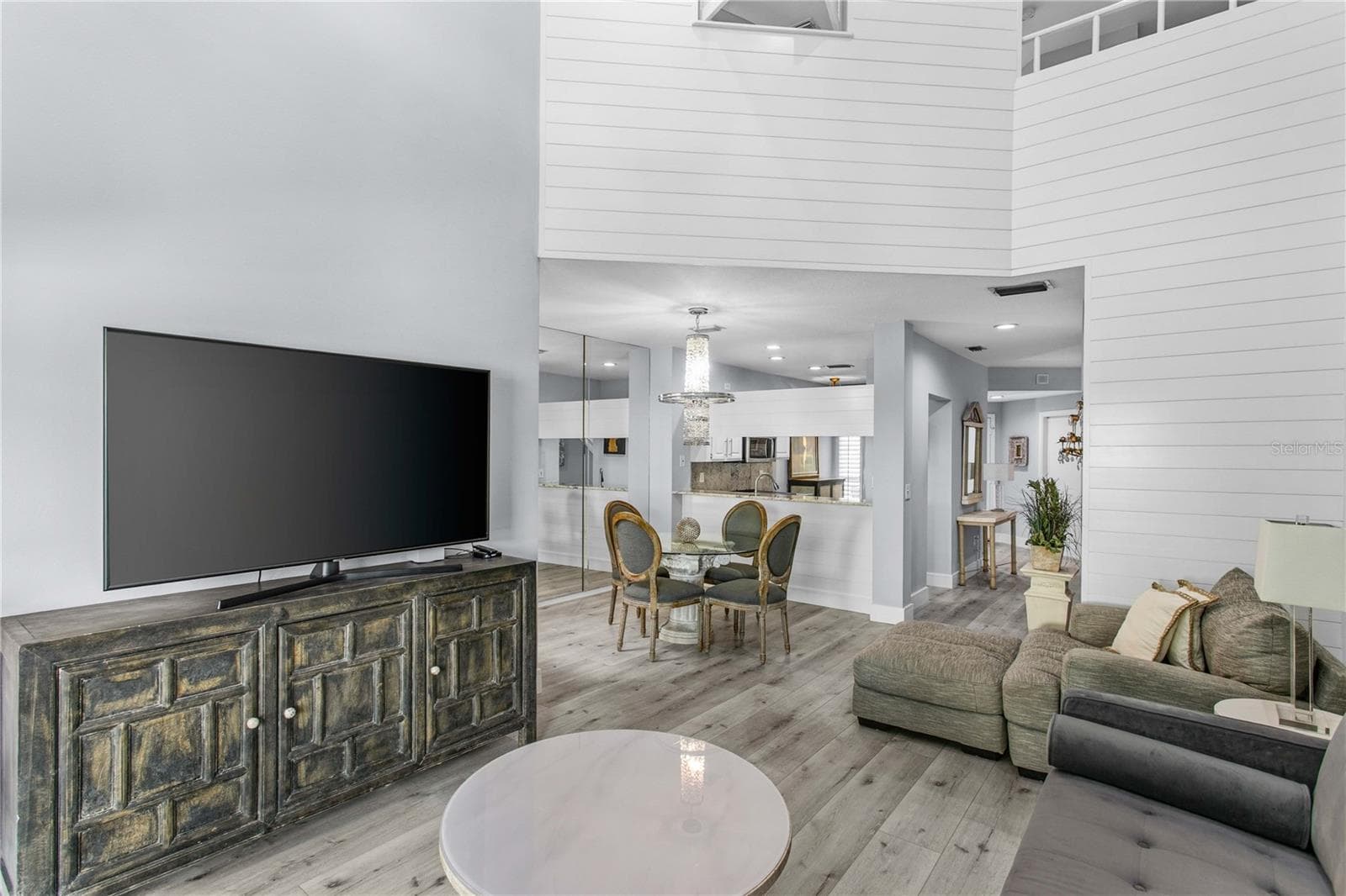 The two-story shiplap feature wall adds architectural interest and a warm focal point in the living room. - 1116 SHIPWATCH CIR, TAMPA
