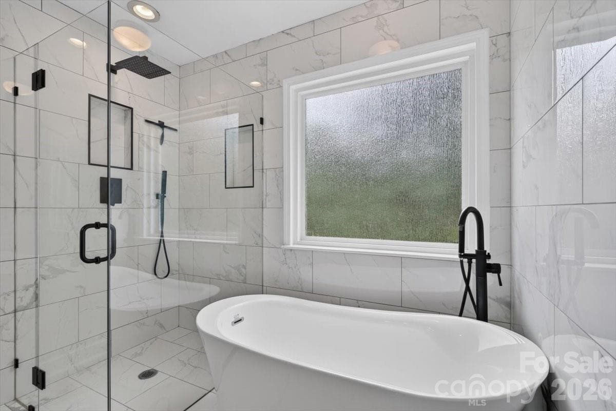 Updated primary bath with stand alone tub and enclosed shower - 8100 Laurel Run Drive, Charlotte