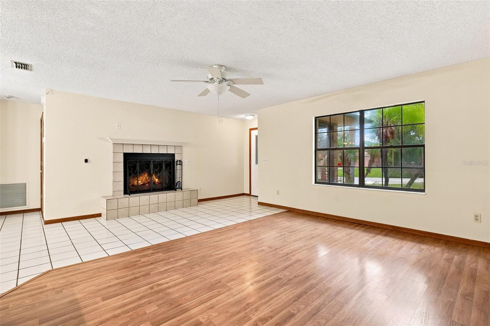 Living room with wood burning fireplace - 226 COUNCIL BLUFFS DR, DELTONA