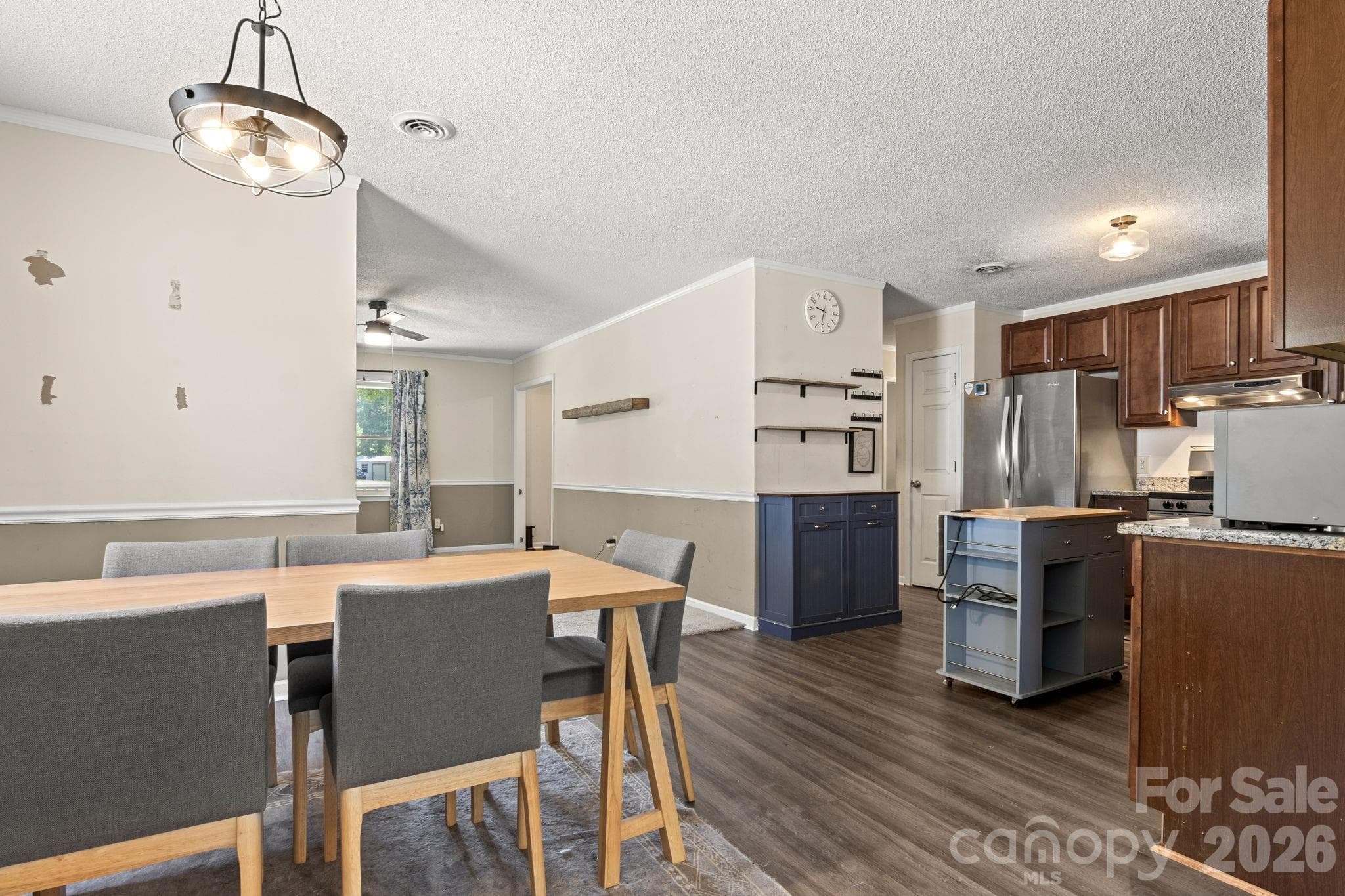 Dining area with new light fixture and view into living room - 1820 Bridgewood Drive, Lancaster