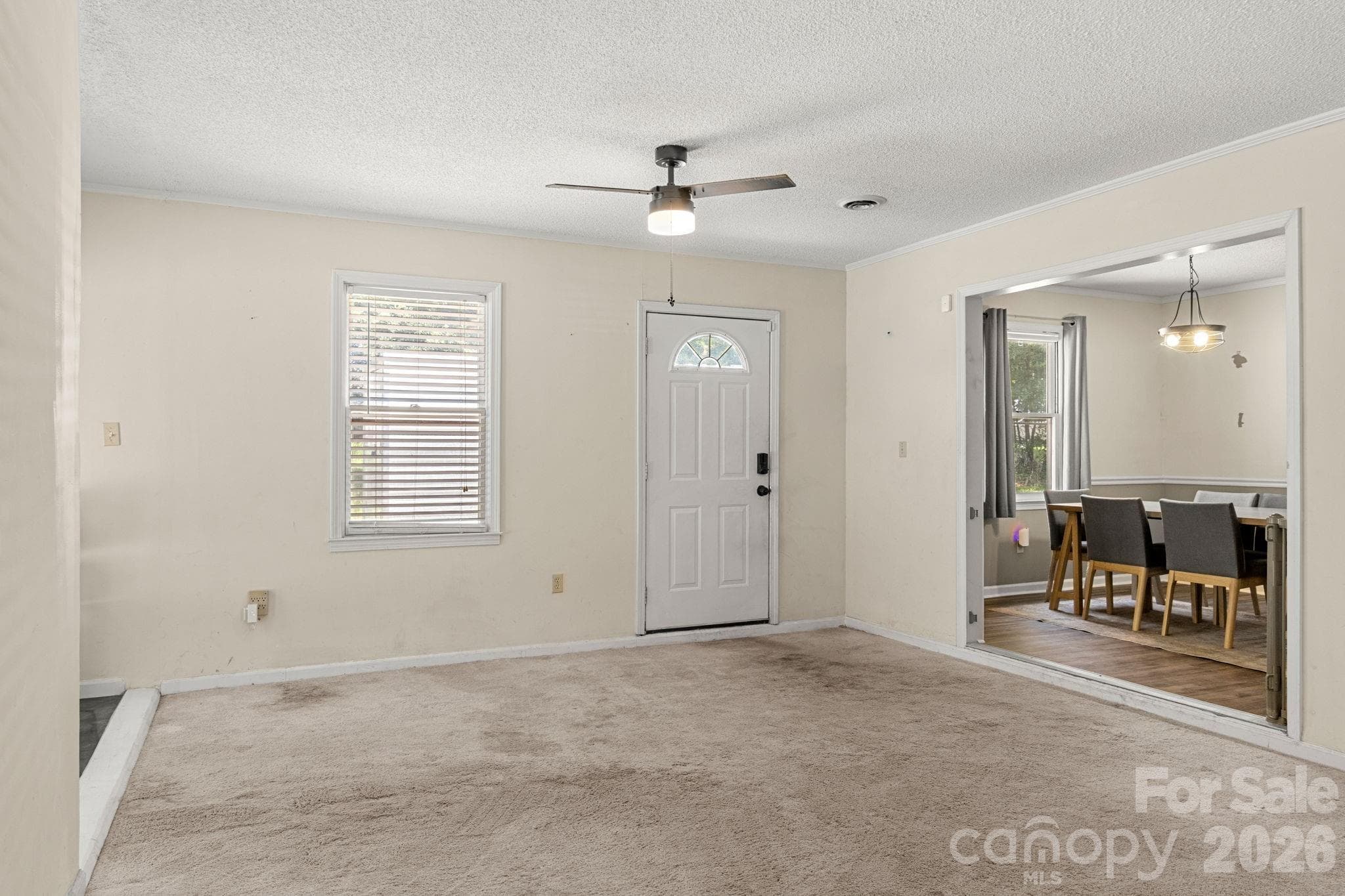 Bonus room with door leading to driveway and view into dining area - 1820 Bridgewood Drive, Lancaster