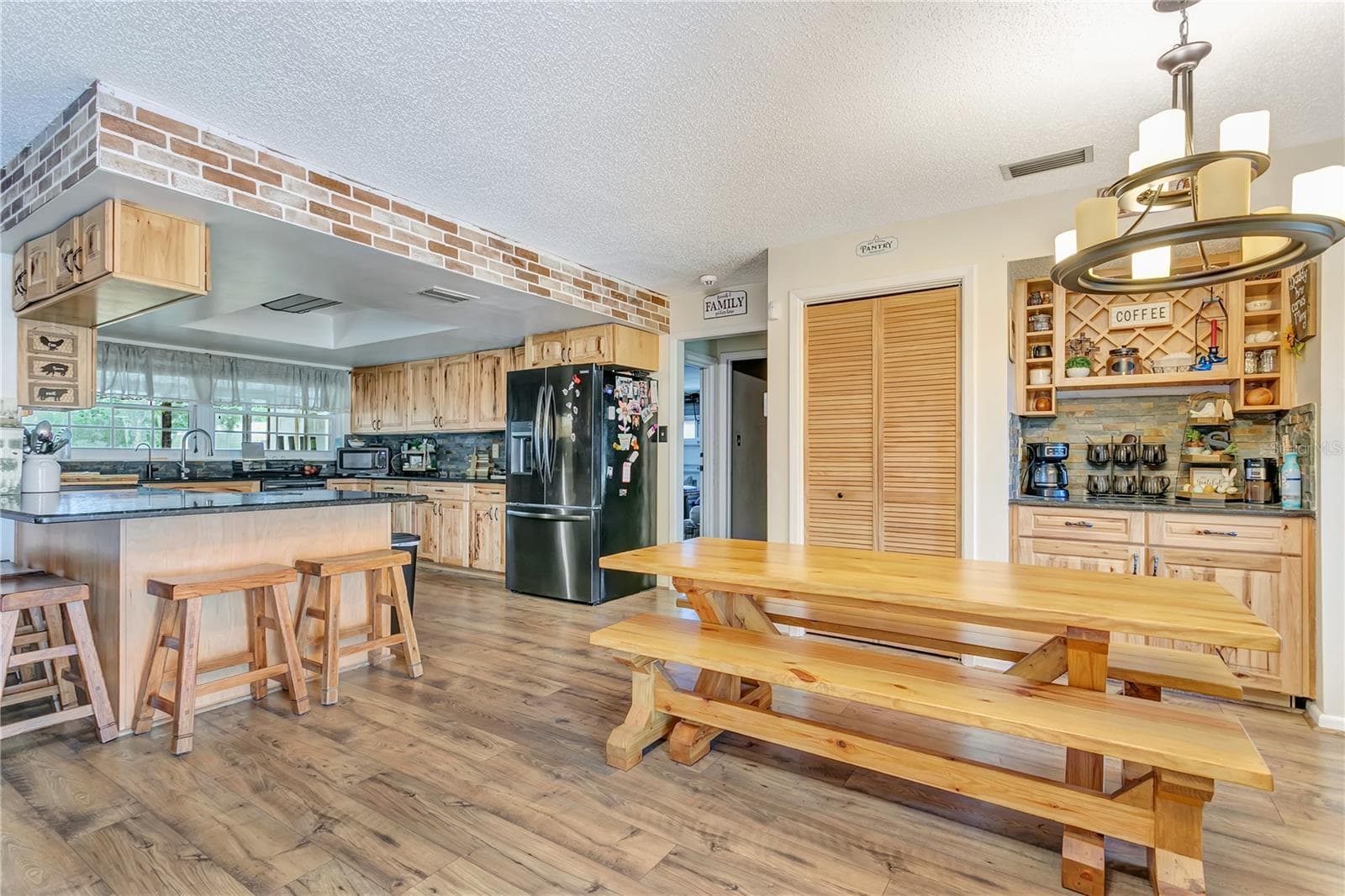 Gorgeous kitchen/Dining area with hickory cabinets and a breakfast bar in the dining room - 10710 BILL TUCKER RD, WIMAUMA