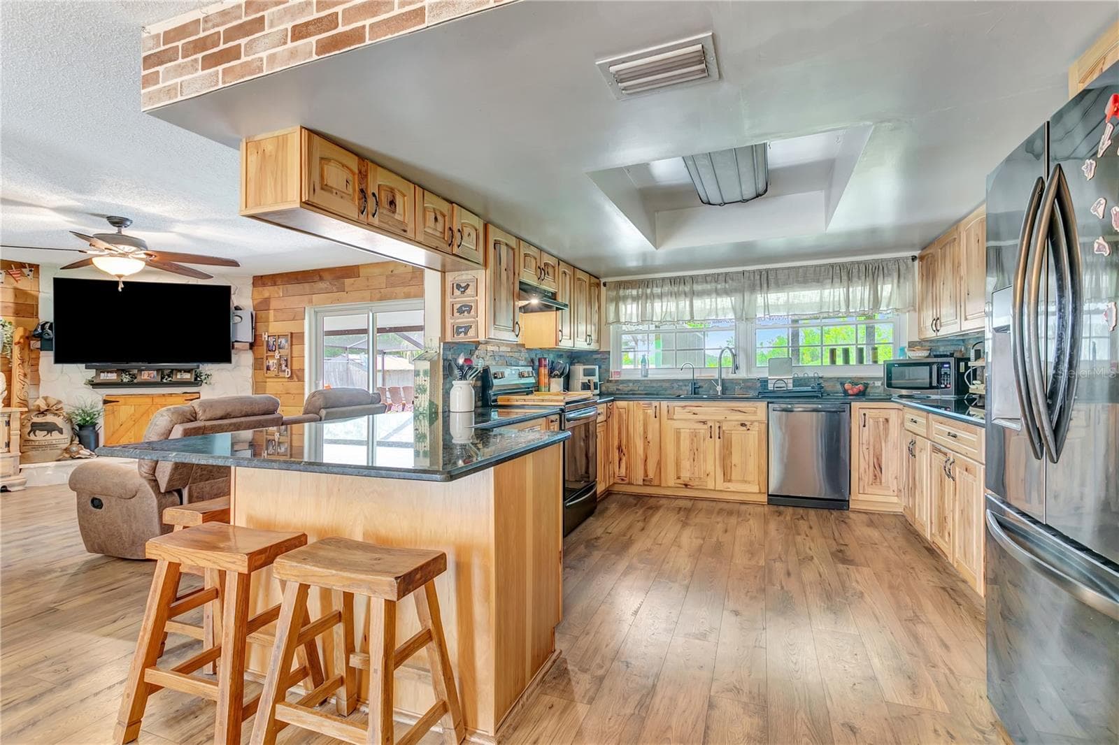 Kitcehn with granite countertops, Stainless appliances and hickory cabinetry - 10710 BILL TUCKER RD, WIMAUMA