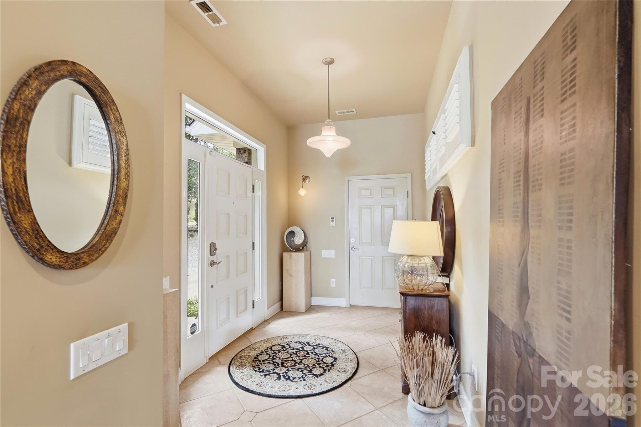 This custom built home boasts specialized features such as Italian lighting fixtures, lighting dimmers, sound system speakers on both levels and on screen porch - 1075 Lakefront Woods Drive, Belmont