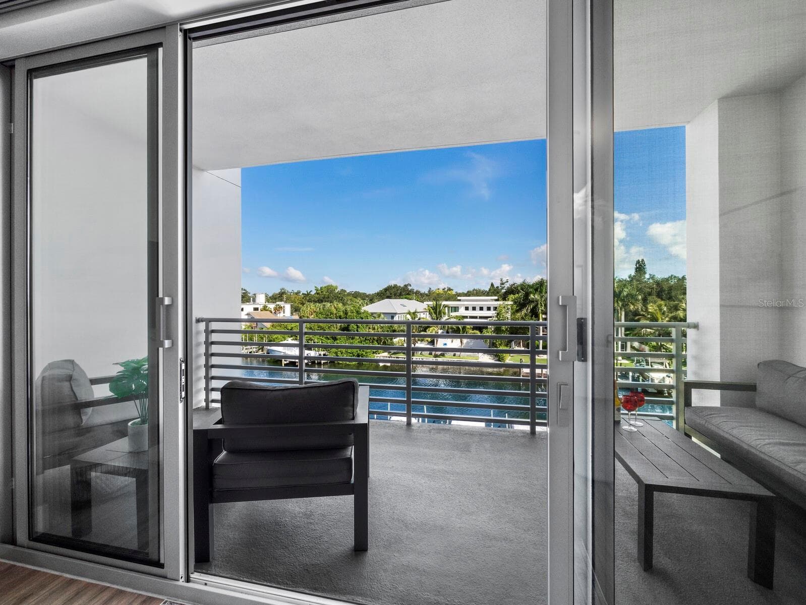 Impact sliders open to private balcony - 1709 N TAMIAMI TRL #418, SARASOTA