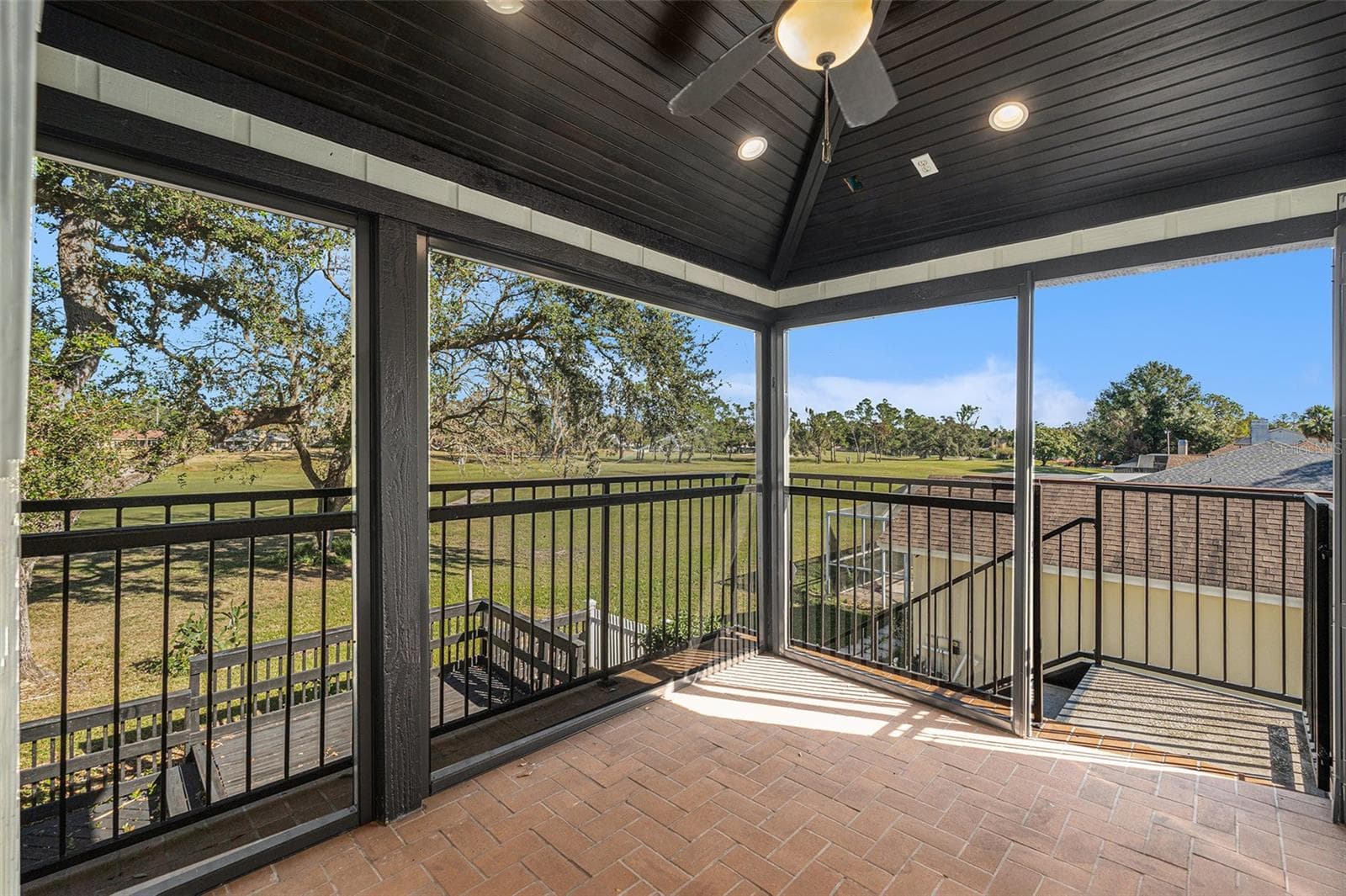 Screened lanai off of primary bedroom overlooking golf course - 4611 LANDSCAPE DR, TAMPA