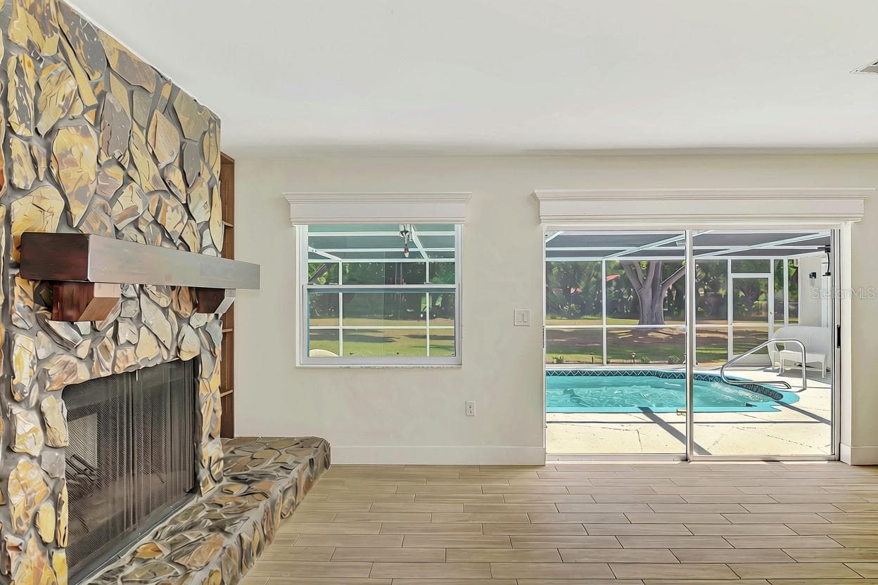 Wood burning stone fireplace out to the pool! - 1620 MISSION VALLEY BLVD, NOKOMIS