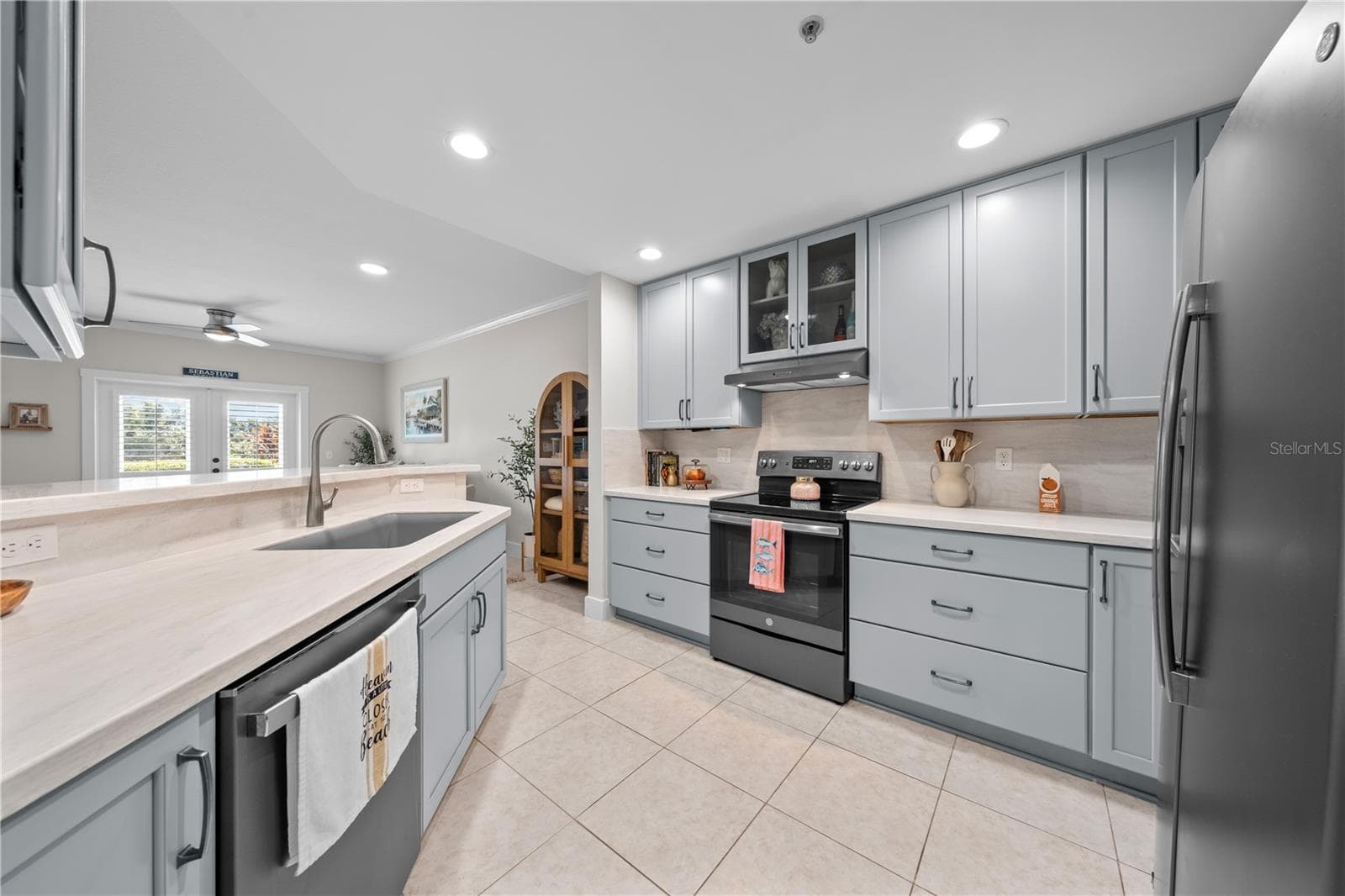 Kitchen features showcase cabinets, quartz countertops and stainless appliances. - 13570 MYSTIC DR #102, SEBASTIAN