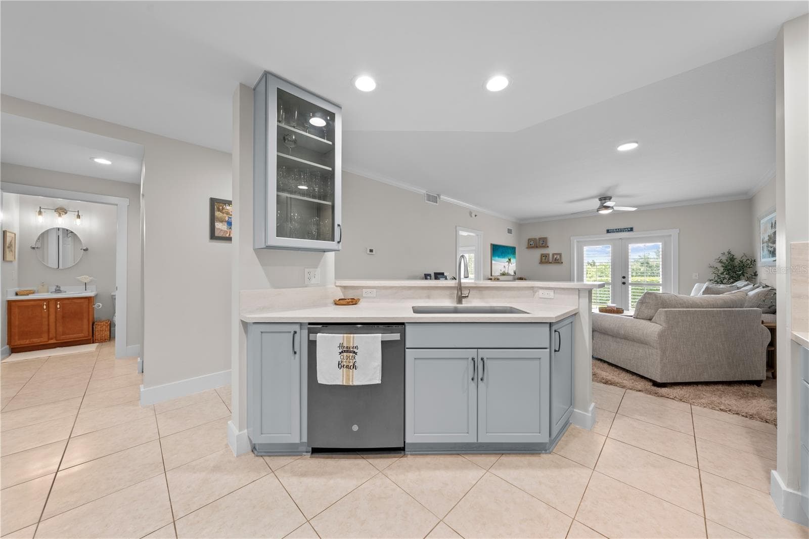 Kitchen features showcase cabinets, quartz countertops and stainless appliances. - 13570 MYSTIC DR #102, SEBASTIAN