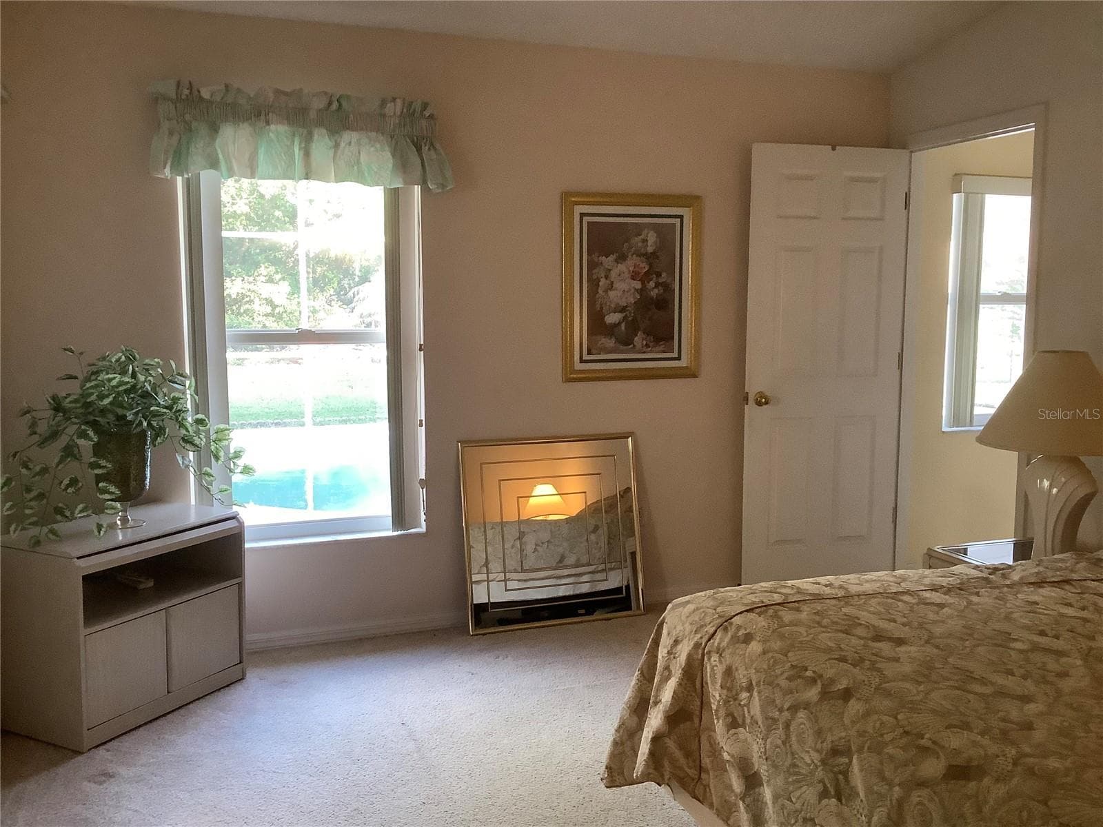 Primary bedroom with window view to pool - 665 STEVELYNN CIR, WINTER GARDEN
