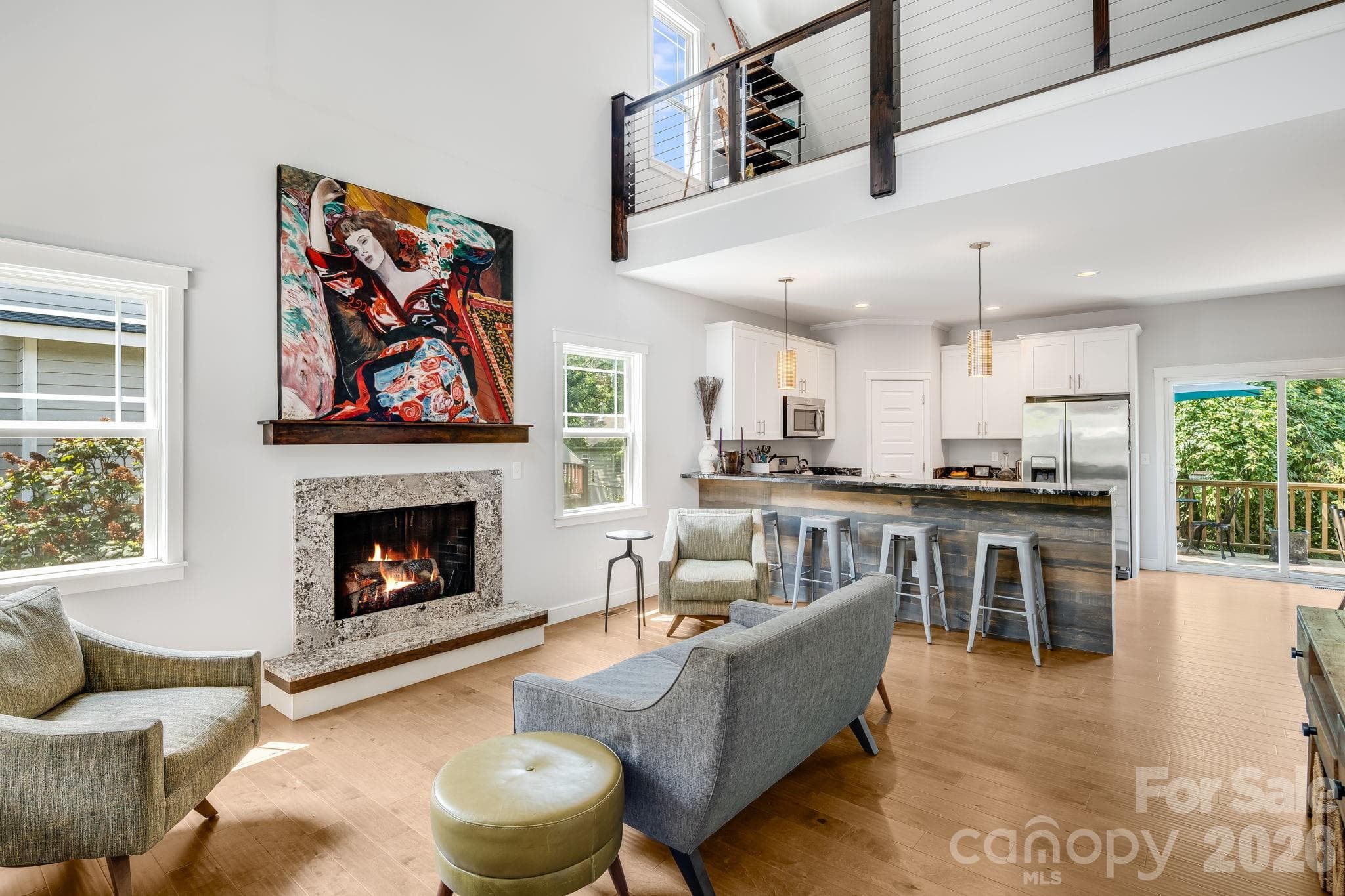 A well lit space with an inviting fireplace to entertain guests. - 35 Emmett Lane, Asheville