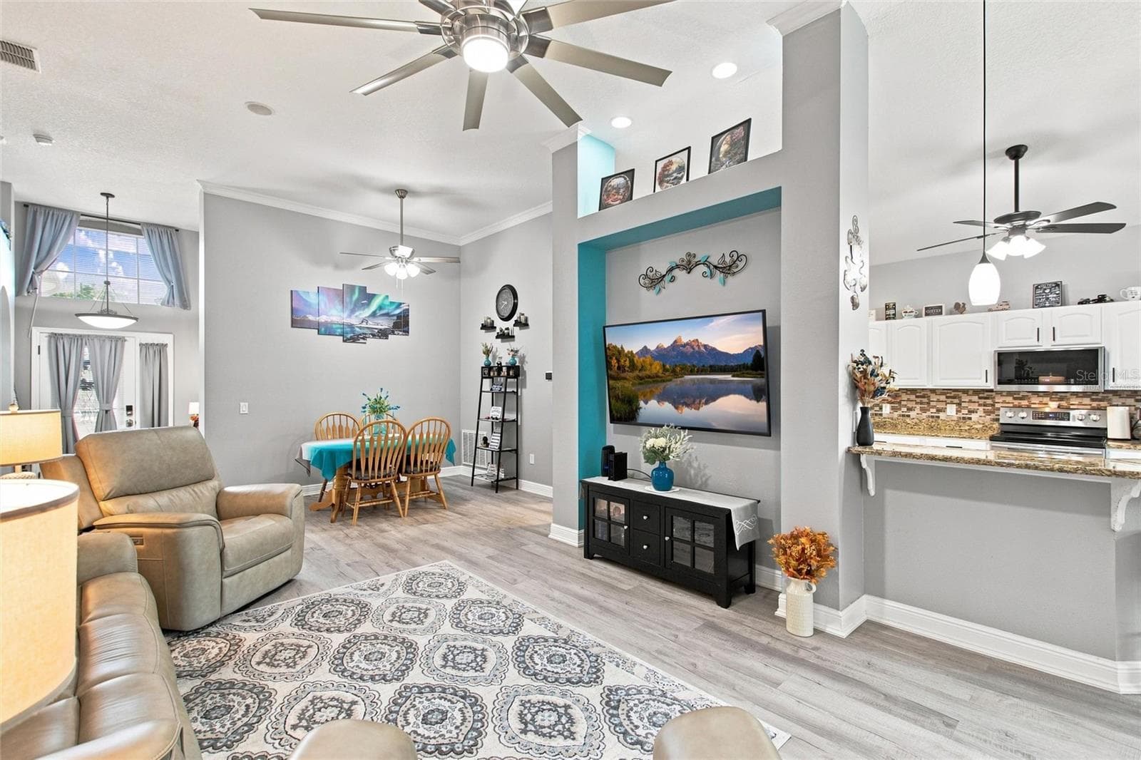 Central Great Room with 12 FT ceiling and virtually staged TV - 919 ASHTON DR, DAVENPORT