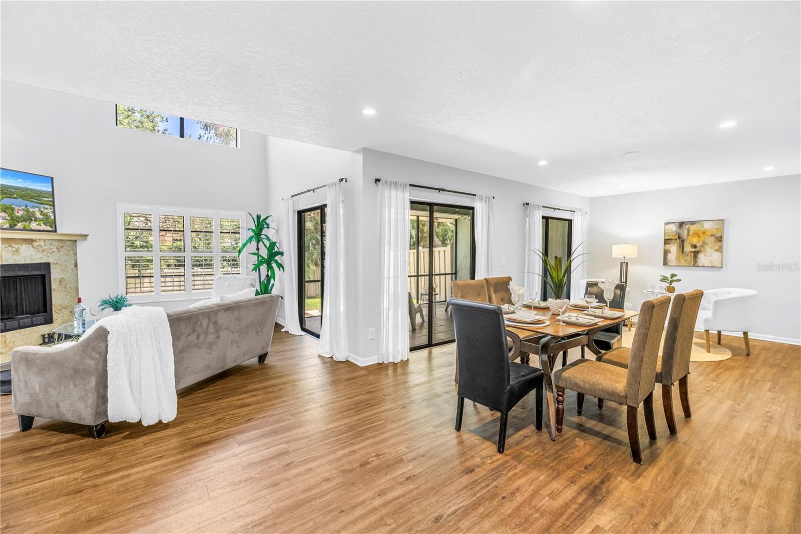 3 Sets of Glass Sliders Access the Open Indoor Living Space to the Outdoors. - 1092 SANABEL CT NE, ST PETERSBURG