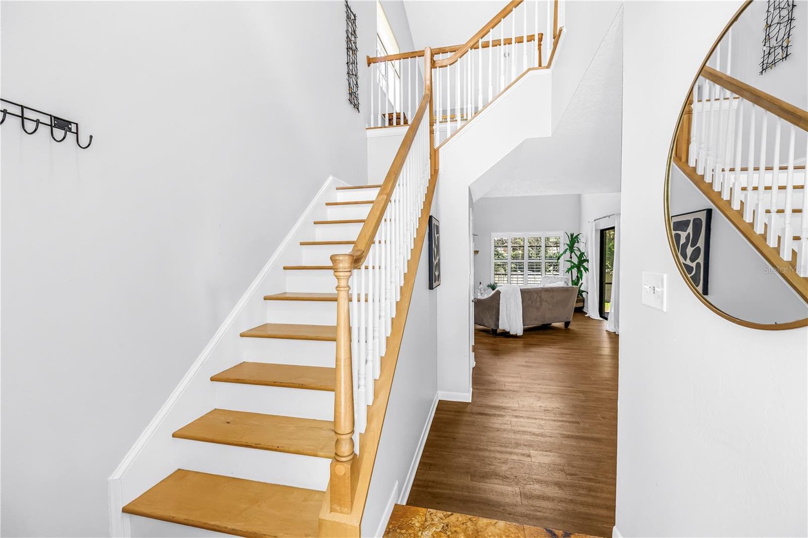 Open Feel for Stairs with light colored natural wood and soaring ceilings to the upstairs loft and office space - 1092 SANABEL CT NE, ST PETERSBURG