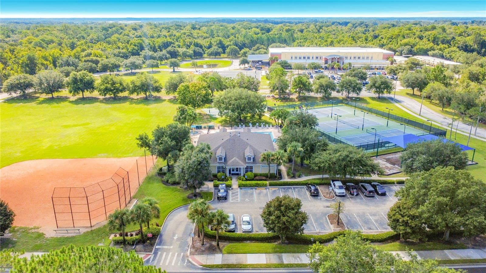 Moss Park Elementary School – the distinctive yellow building in the background, serving the local community. - 9850 HIDDEN DUNES LN, ORLANDO
