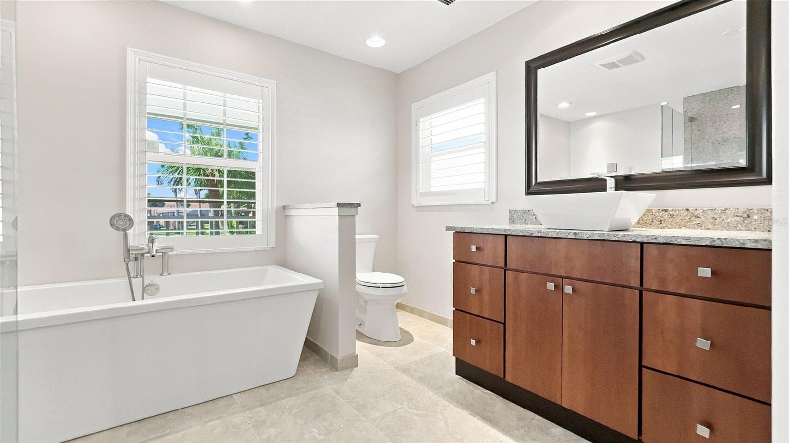 Primary Bath with Soaking tub, high toilet, and vanity - 342 N 12TH ST, FLAGLER BEACH