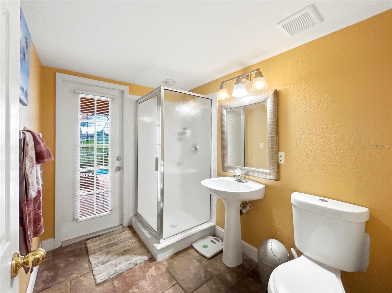 GUEST AND POOL BATHROOM WITH MARDI GRAS TILE WHICH IS NOT SLIPPERY AND PERFECT AS IT'S EASY ACCESS FOR POOL GUESTS. 3 ENTRY DOORS FROM THE POOL. - 936 ALLEGRO LN, APOLLO BEACH