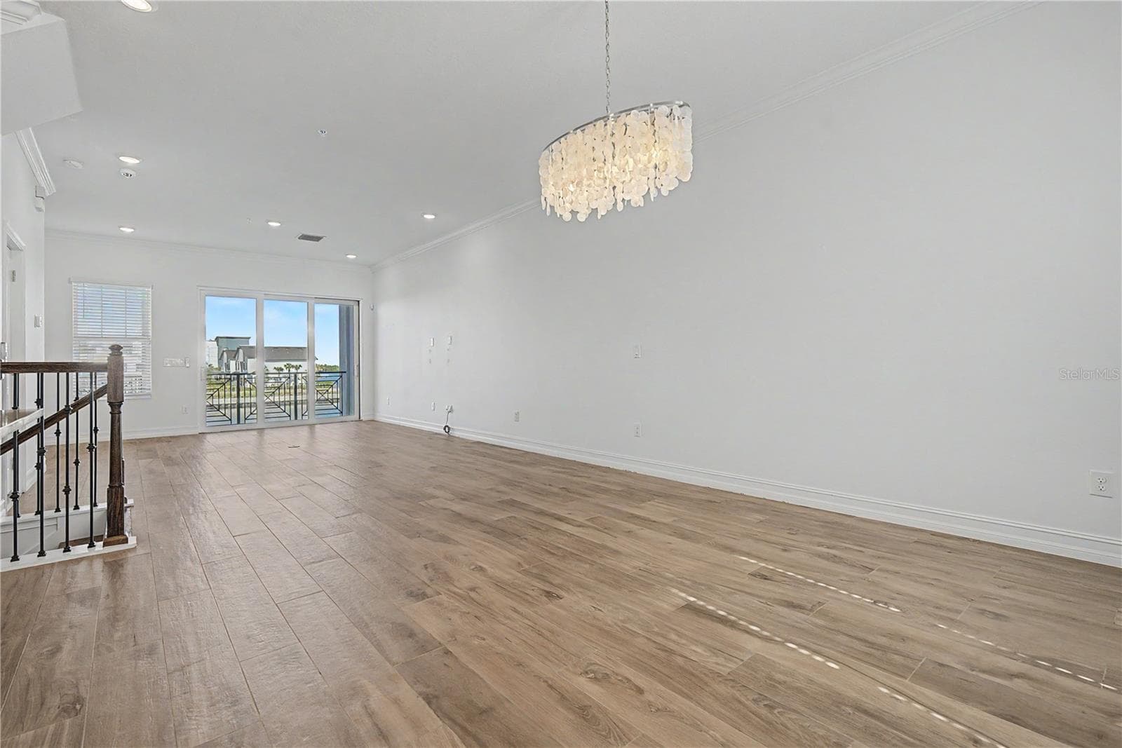 Second-level living area viewed from the kitchen, highlighting the open-concept layout. - 5351 BRIDGE ST #38, TAMPA