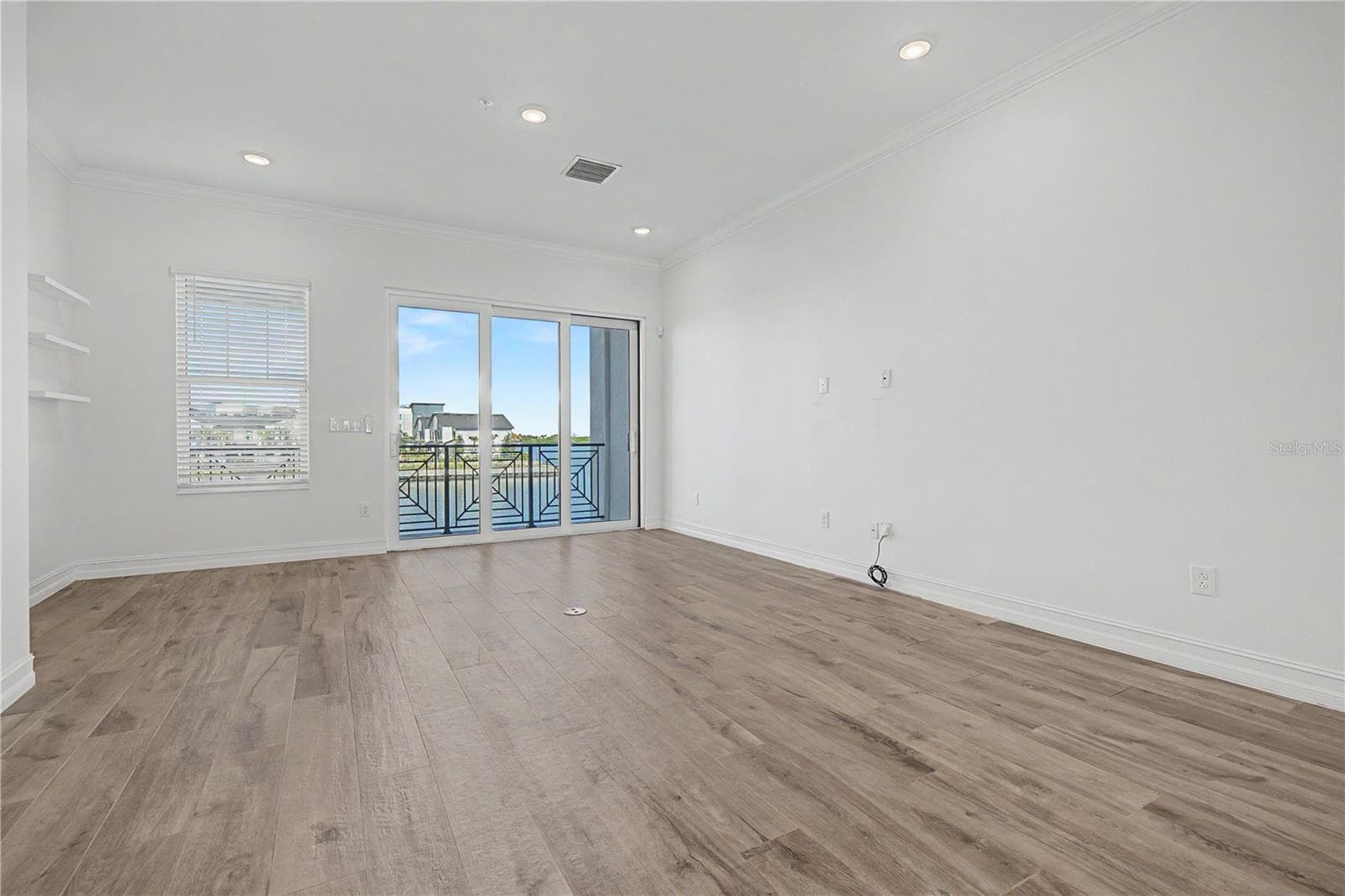 Second-level living area with a bright, open, and inviting feel straight to sliding doors that lead to an amazing outdoor patio. - 5351 BRIDGE ST #38, TAMPA